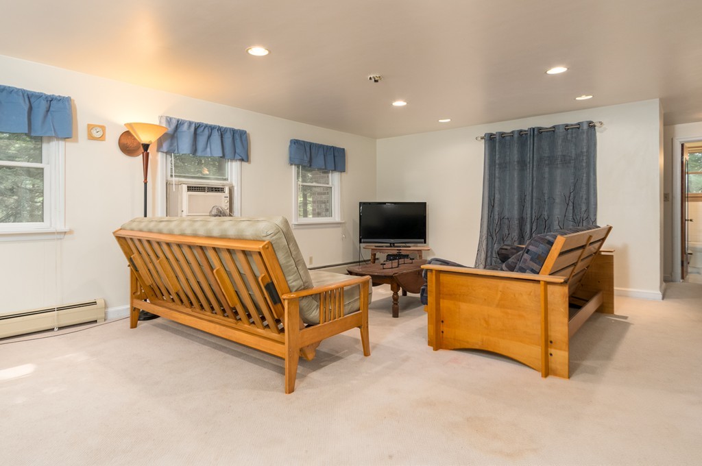 22 Leigh Road Wenham, MA 01984 - Photo 6 of 28 a living room with furniture and a flat screen tv