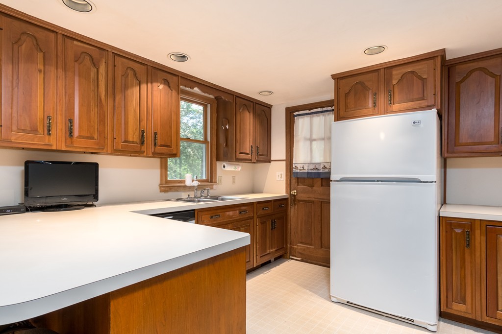 22 Leigh Road Wenham, MA 01984 - Photo 8 of 28 a kitchen with a refrigerator a stove and a microwave