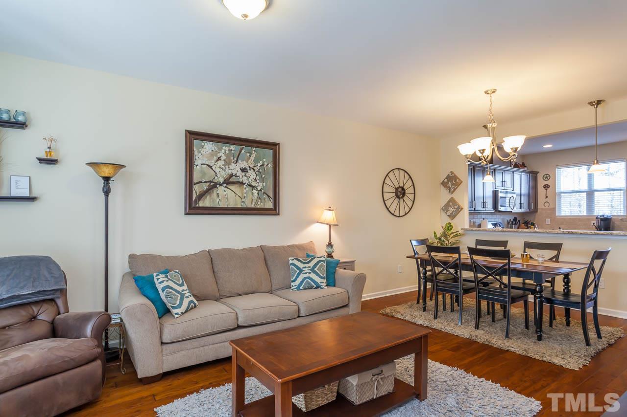 1651 Crafton Way Raleigh, NC 27607 - Photo 5 of 20 a living room with furniture a rug and a dining table