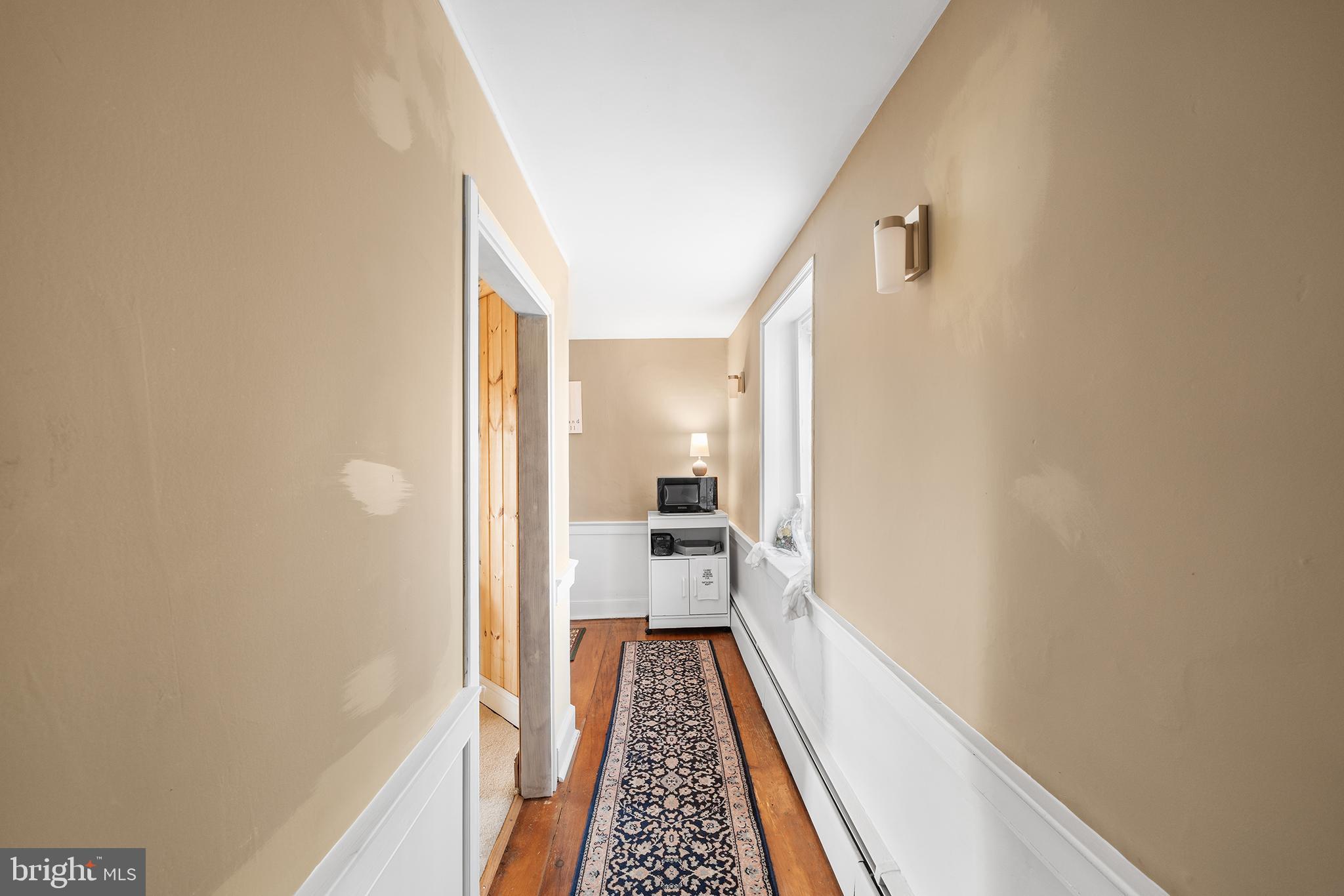 206 Twinbrook Road Perkasie, PA 18944 - Photo 25 of 46 a view of a hallway with wooden floor and staircase