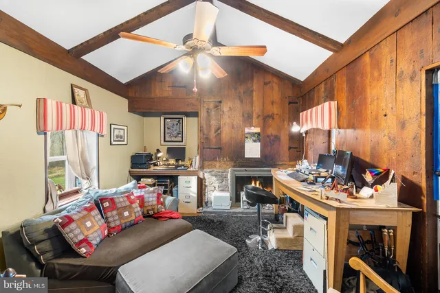 a living room with furniture and a dining area with a fireplace