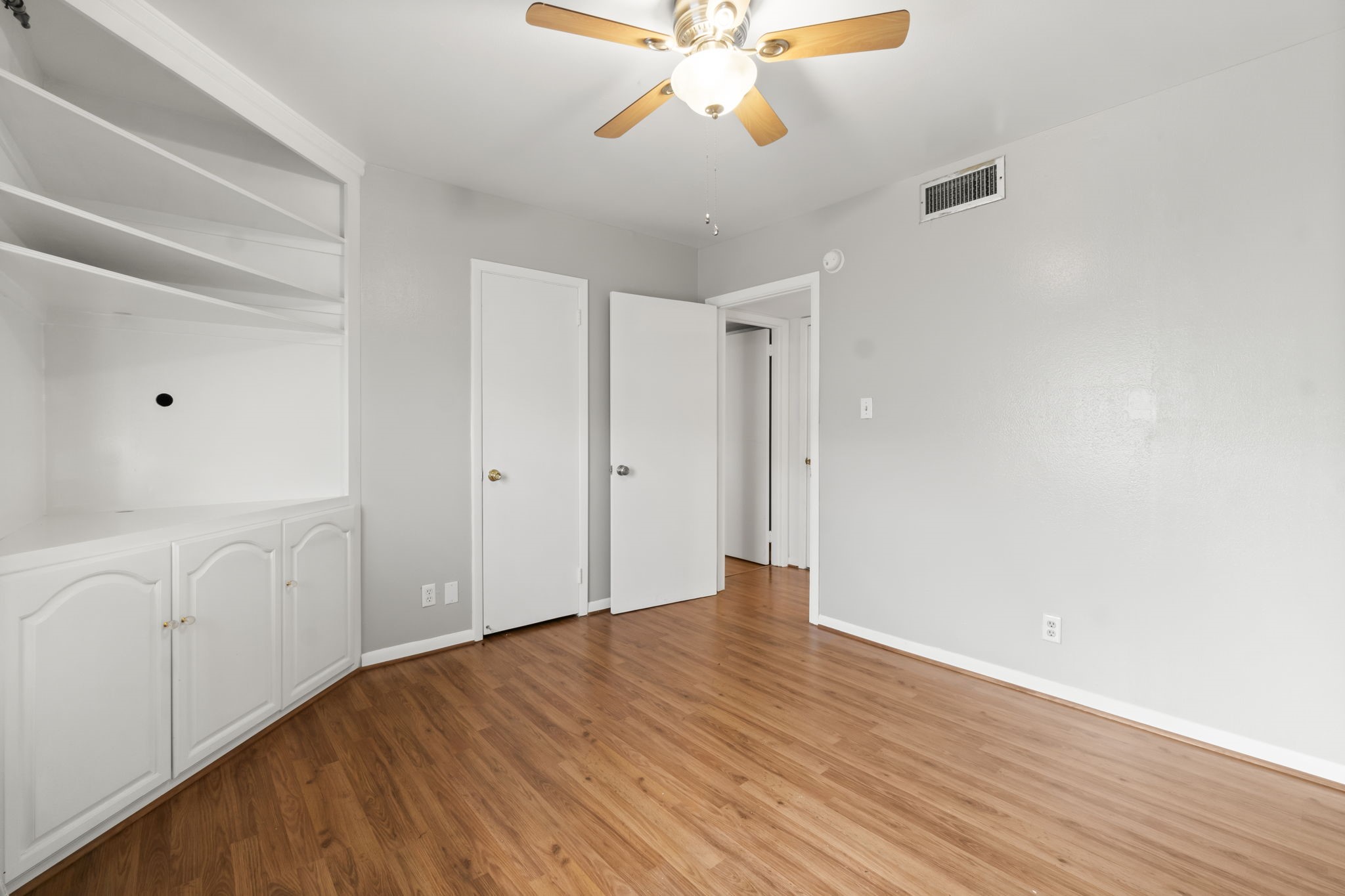 2824 Briarhurst Drive, Unit 14 Houston, TX 77057 - Photo 12 of 26 a view of an empty room with window and wooden floor