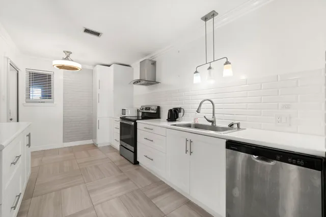 a kitchen with cabinets a sink and appliances
