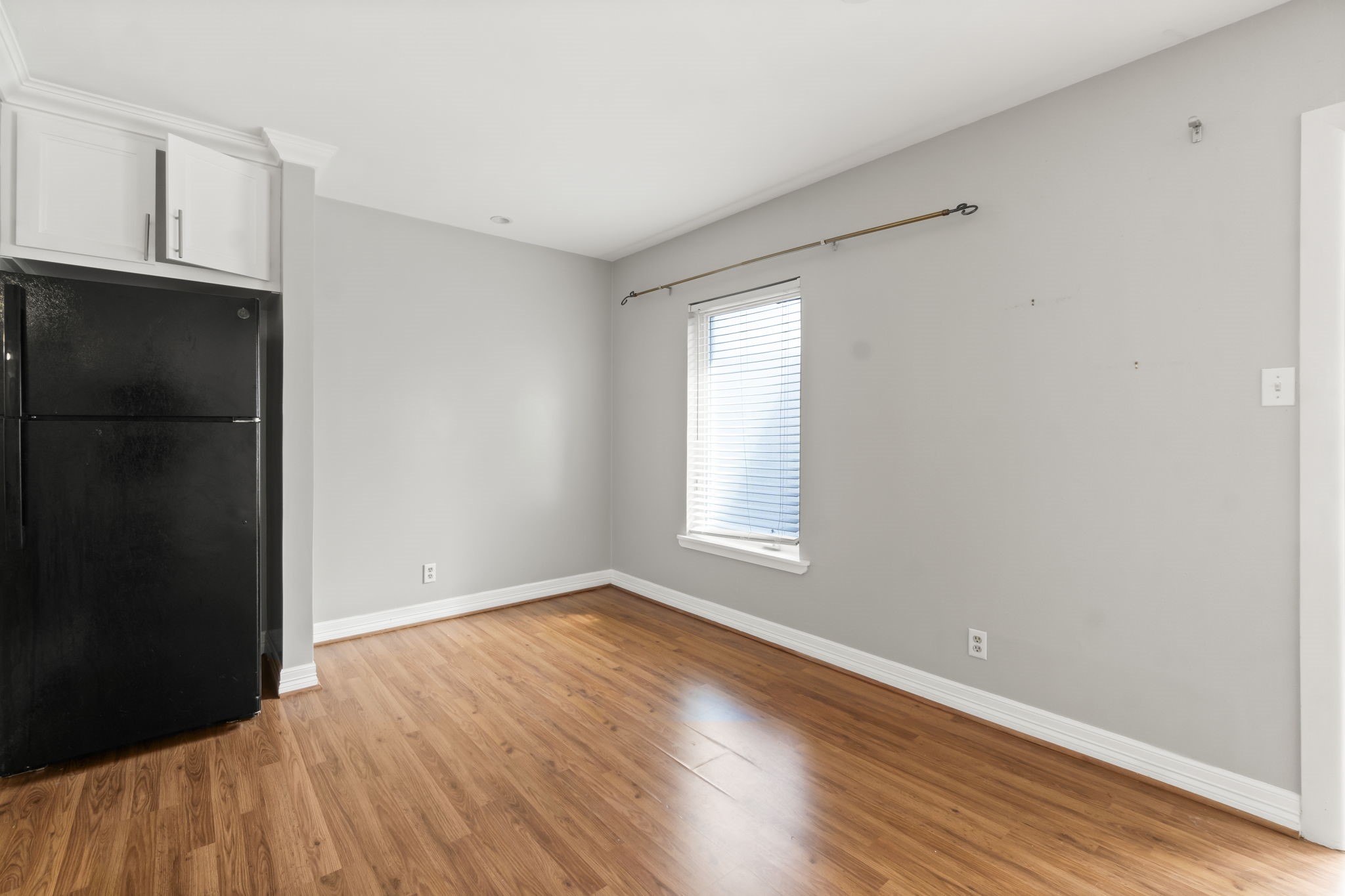 2824 Briarhurst Drive, Unit 14 Houston, TX 77057 - Photo 8 of 26 a view of an empty room with wooden floor and a window