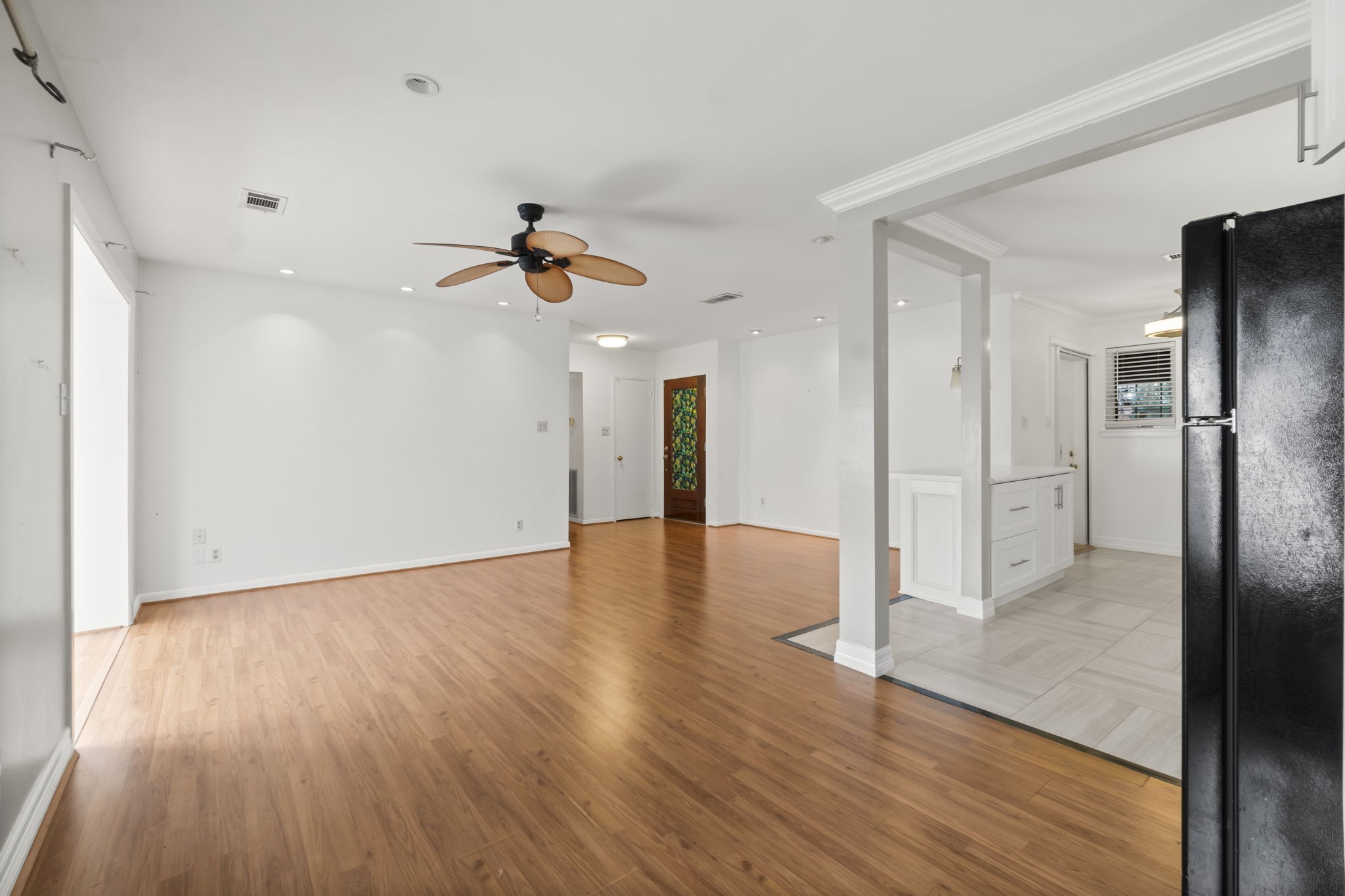 2824 Briarhurst Drive, Unit 14 Houston, TX 77057 - Photo 9 of 26 a view of a kitchen with wooden floor a sink and a refrigerator