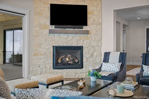a living room with furniture fireplace and flat screen tv