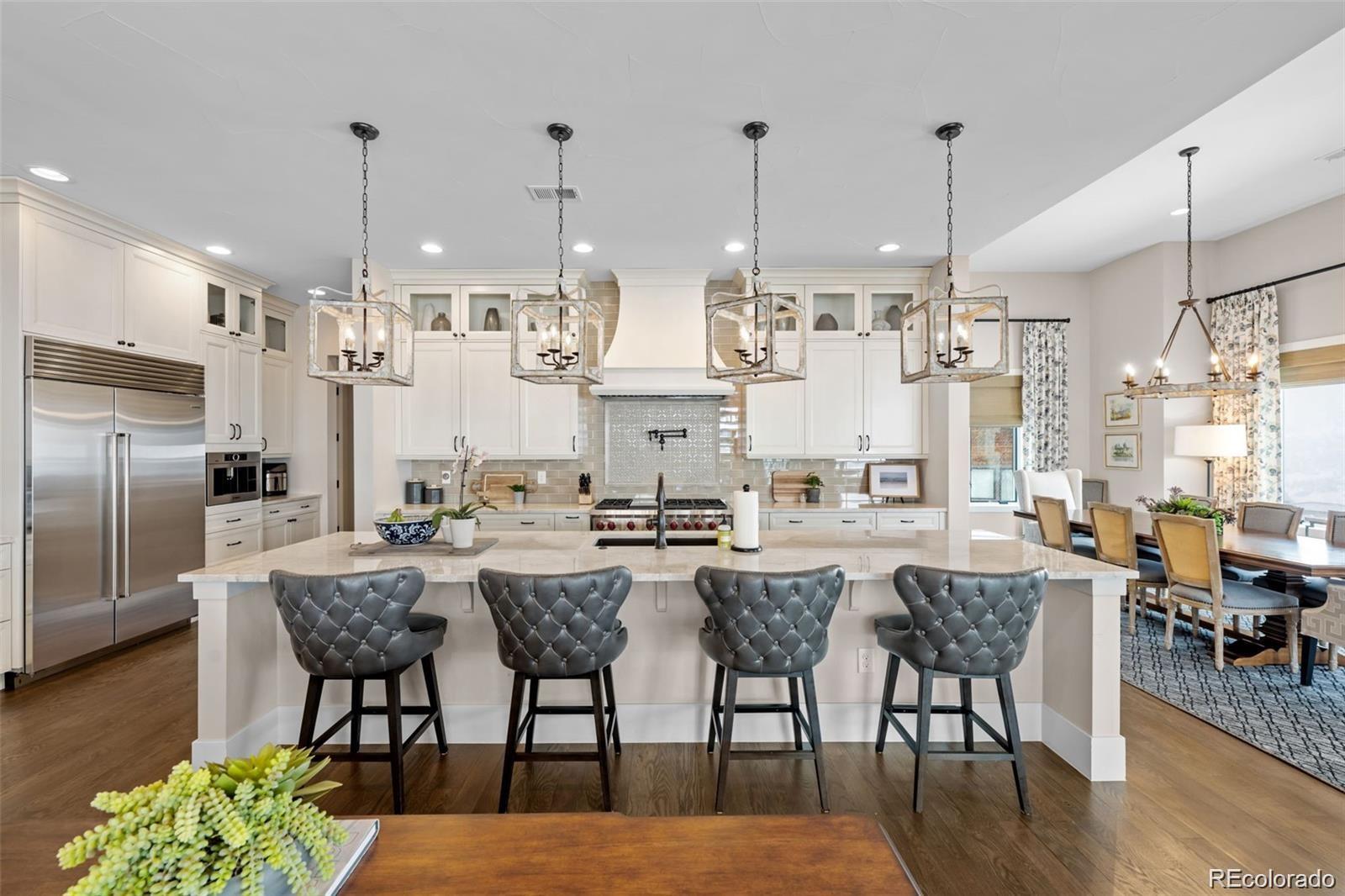 7912 Raphael Lane Littleton, CO 80125 - Photo 13 of 50 a large kitchen with a table and chairs