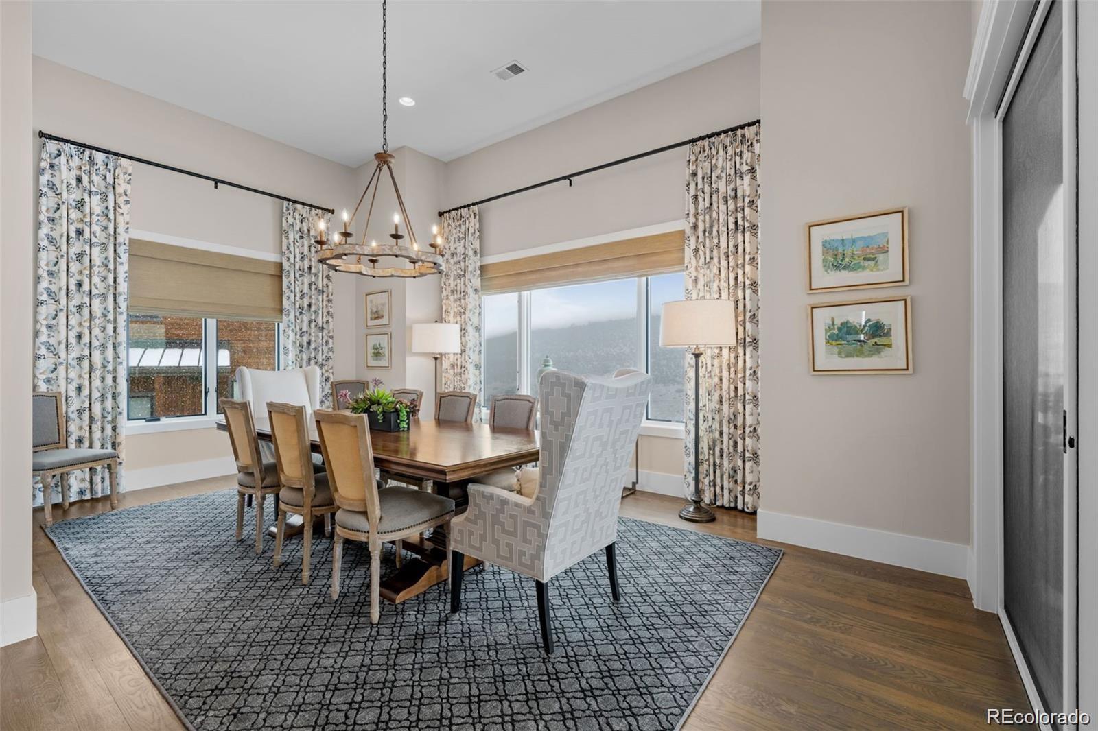 7912 Raphael Lane Littleton, CO 80125 - Photo 16 of 50 a view of a dining room with furniture and chandelier