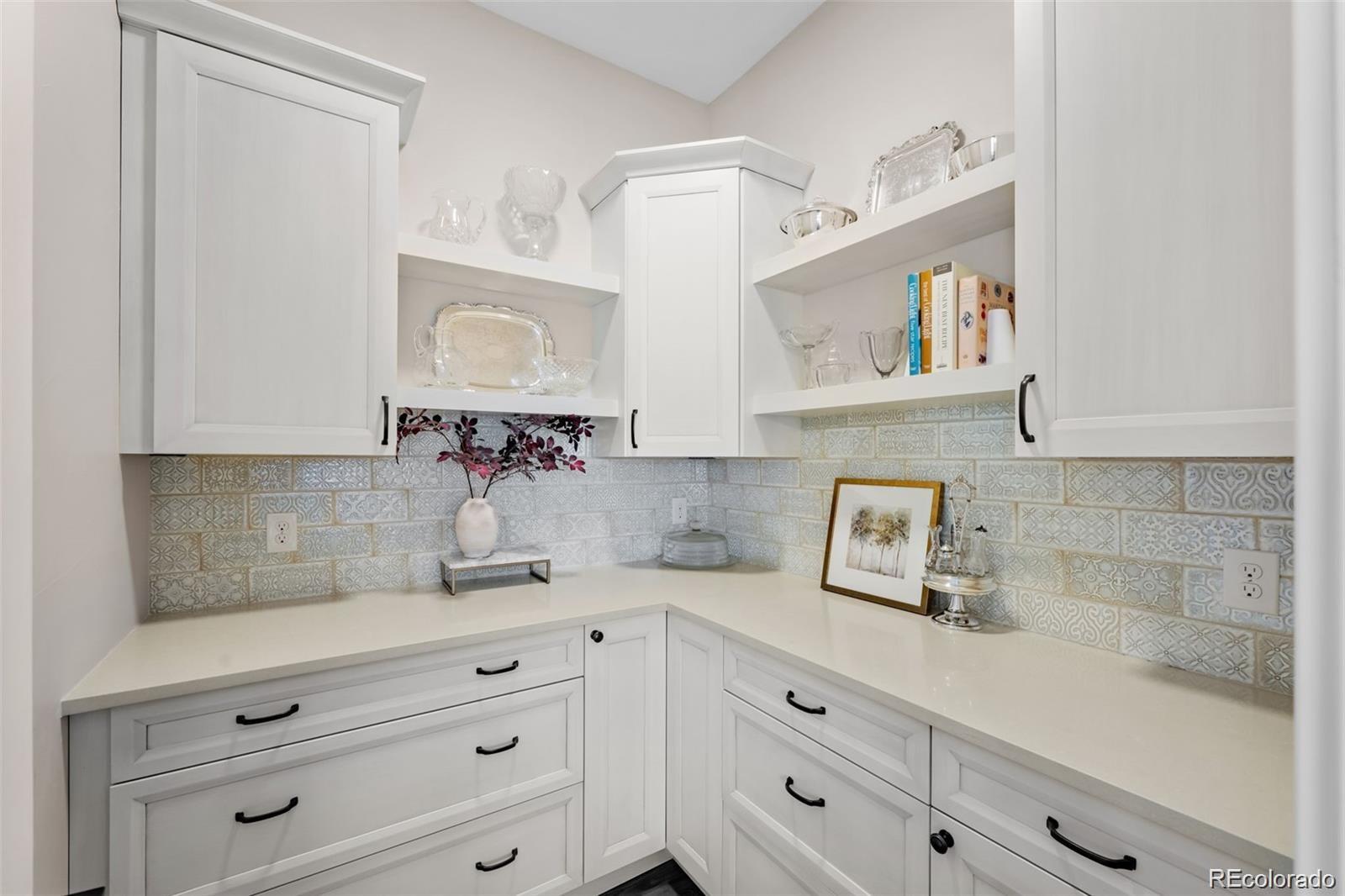 7912 Raphael Lane Littleton, CO 80125 - Photo 18 of 50 a kitchen with cabinets stainless steel appliances a sink and a window