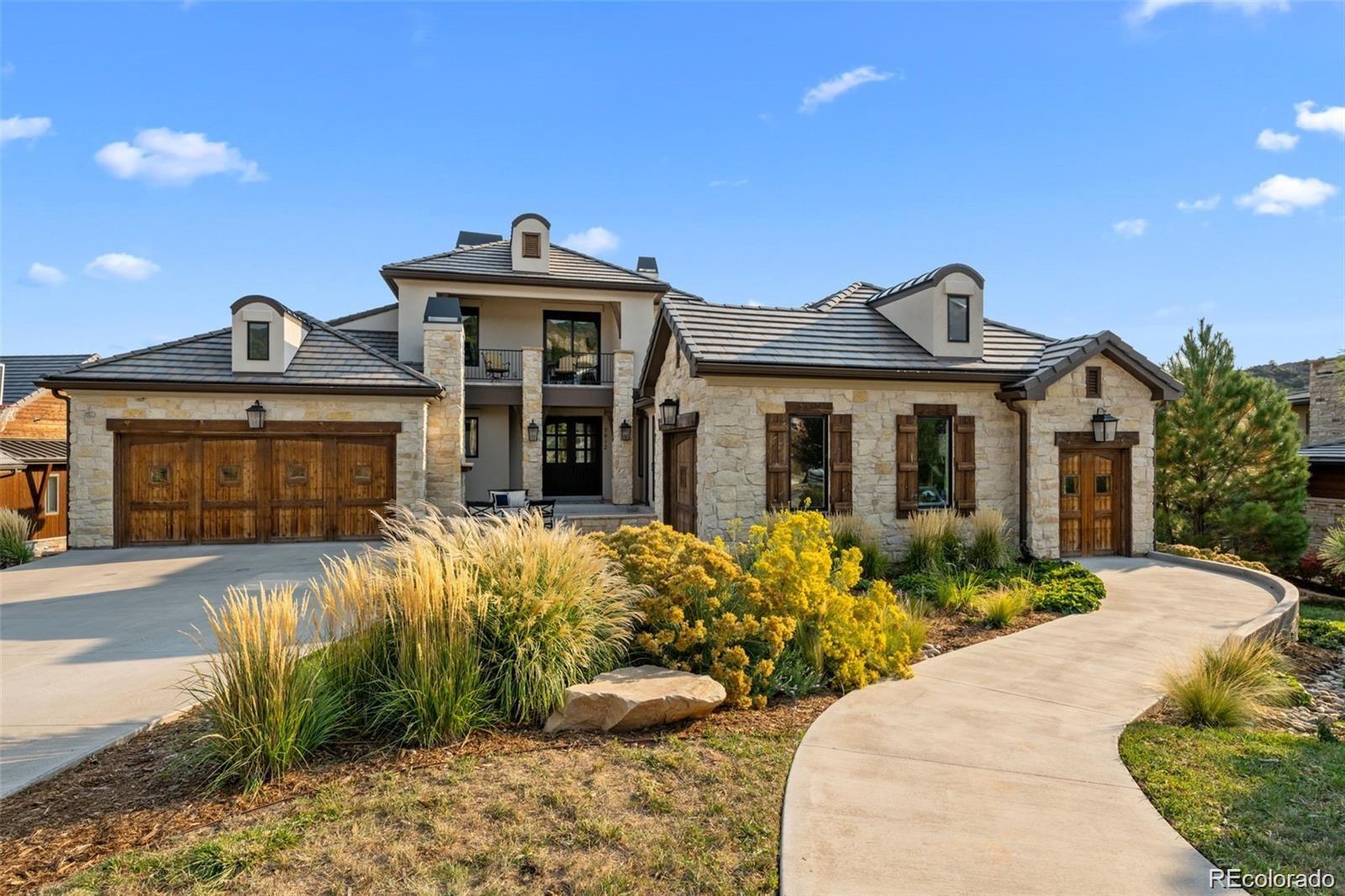 7912 Raphael Lane Littleton, CO 80125 - Photo 2 of 50 a front view of a house with a yard and potted plants