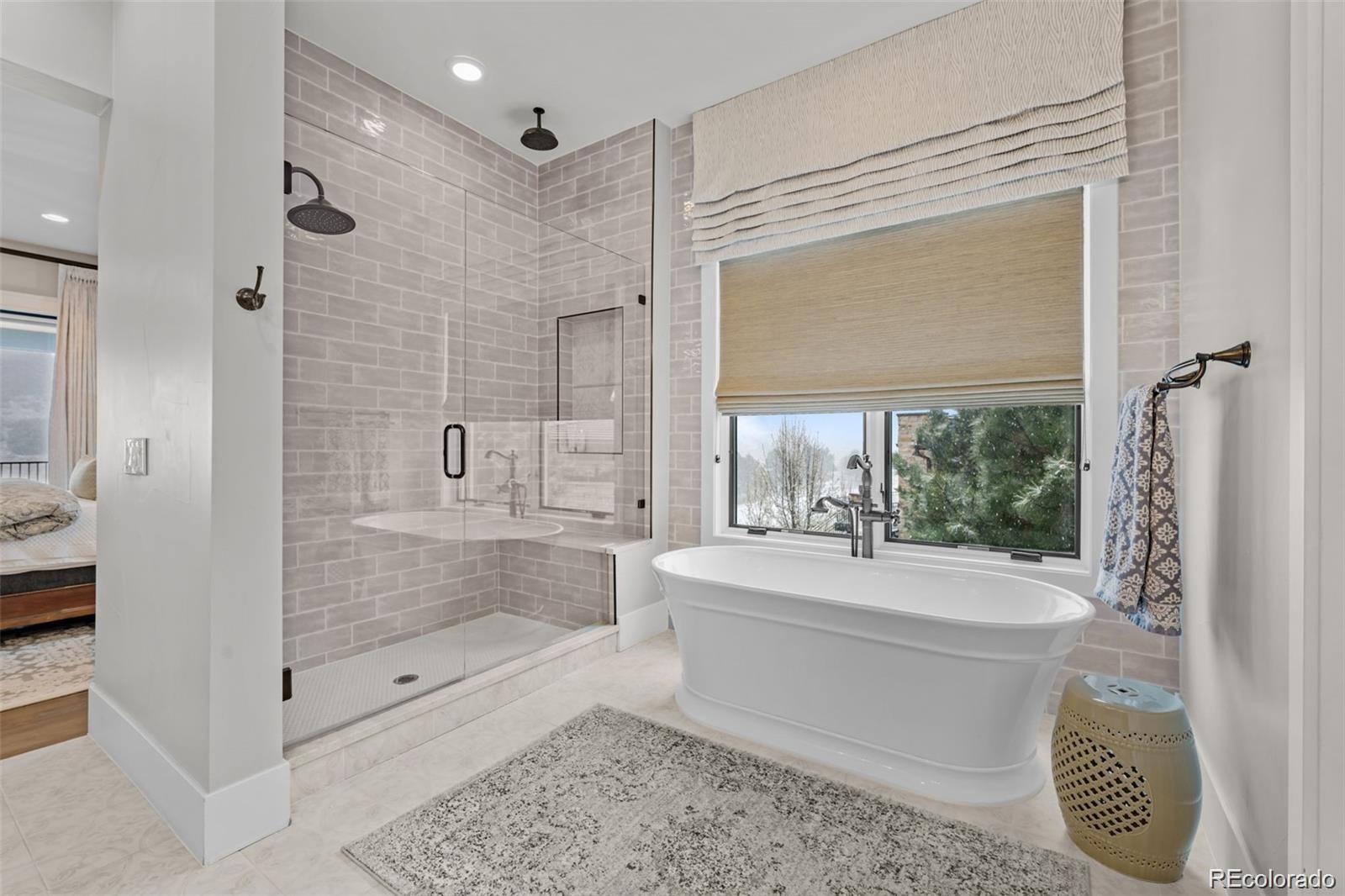 7912 Raphael Lane Littleton, CO 80125 - Photo 24 of 50 a bathroom with a bathtub shower sink vanity and toilet