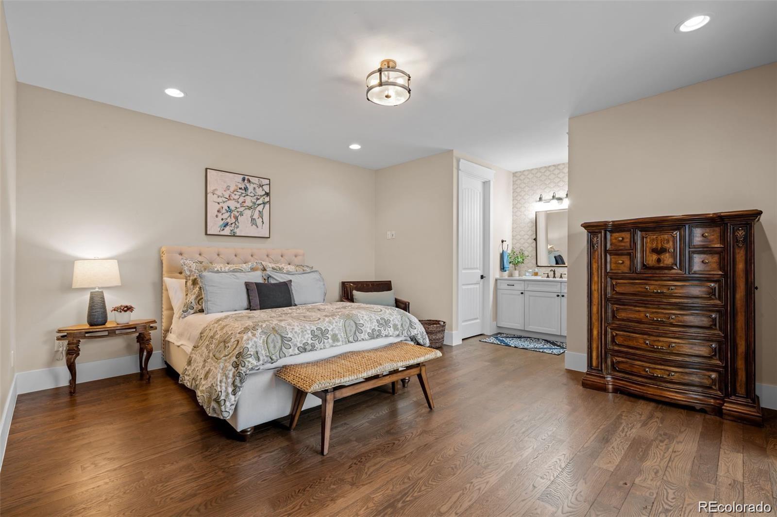 7912 Raphael Lane Littleton, CO 80125 - Photo 28 of 50 a bedroom with a bed and a view of bathroom
