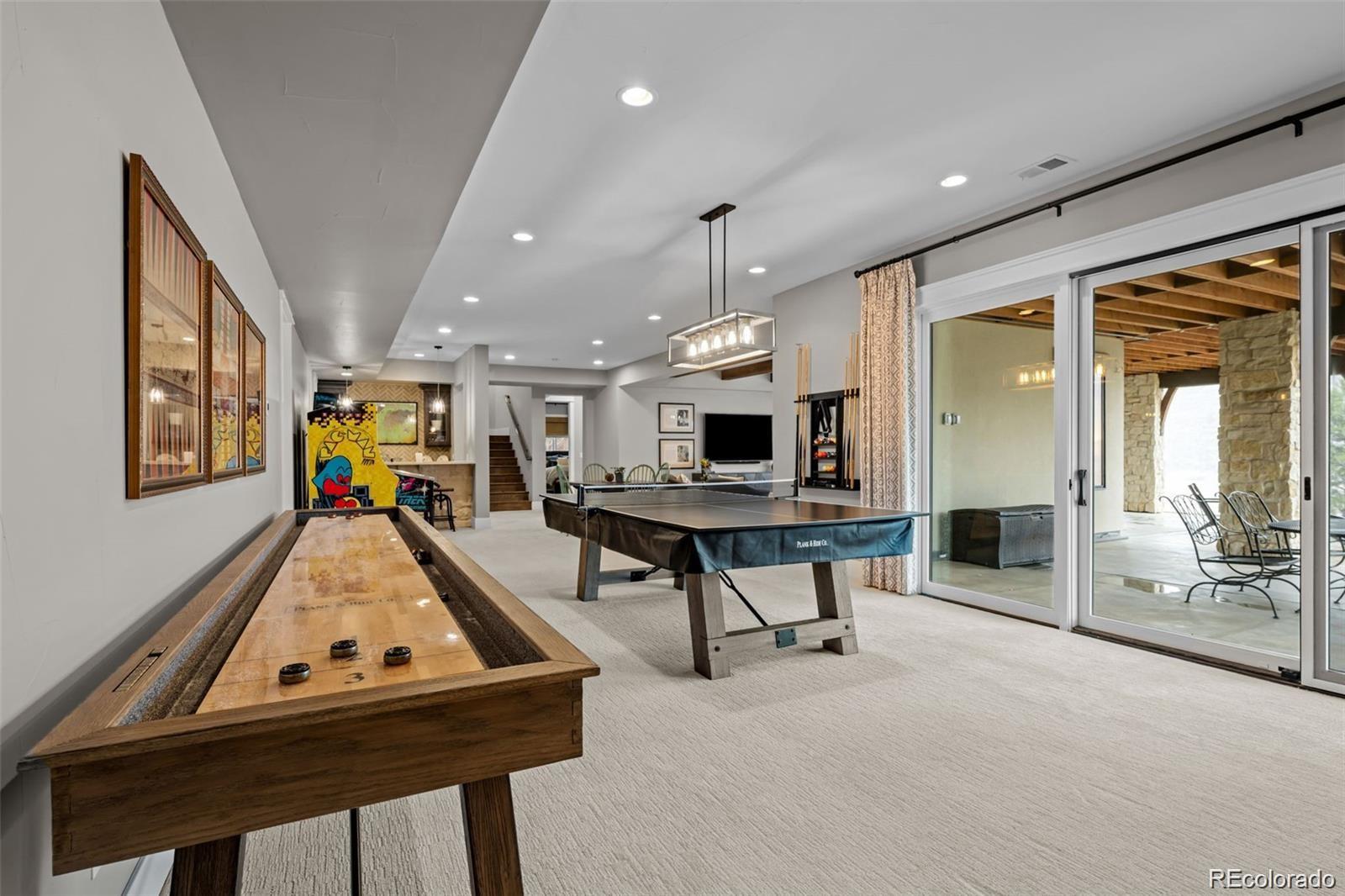 7912 Raphael Lane Littleton, CO 80125 - Photo 35 of 50 a living room with furniture a flat screen tv and a table