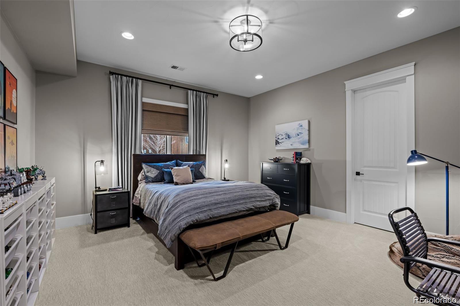 7912 Raphael Lane Littleton, CO 80125 - Photo 36 of 50 a bedroom with a bed window and table chair