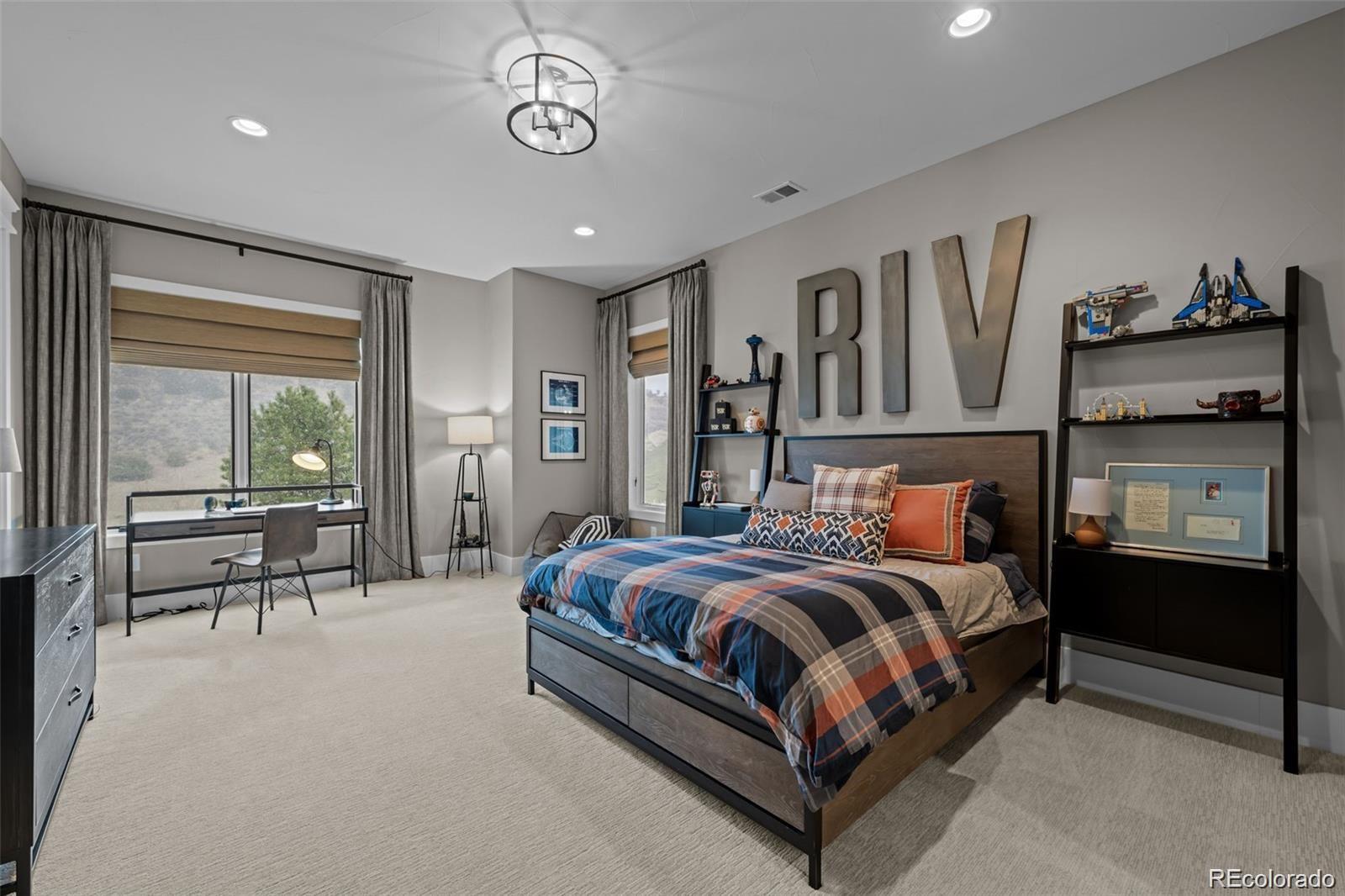 7912 Raphael Lane Littleton, CO 80125 - Photo 38 of 50 a bedroom with a bed and large window