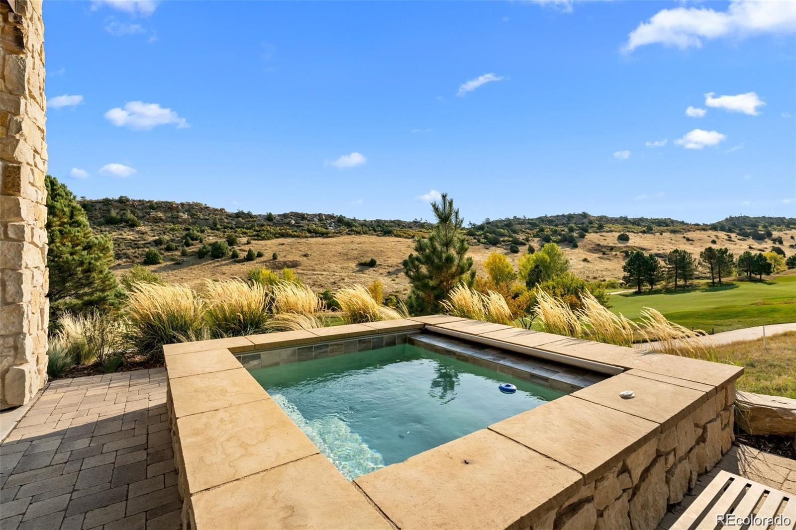 7912 Raphael Lane Littleton, CO 80125 - Photo 47 of 50 a view of a swimming pool with a lake view and mountain view