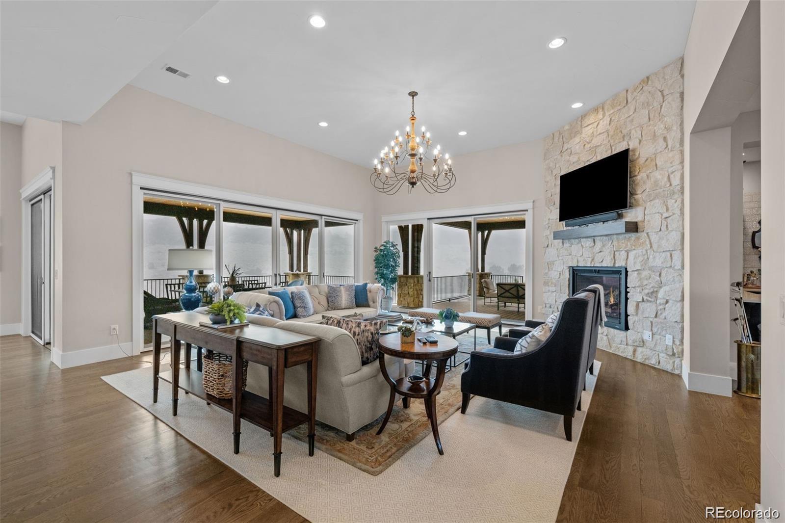 7912 Raphael Lane Littleton, CO 80125 - Photo 9 of 50 a dining room with furniture a fireplace and wooden floor