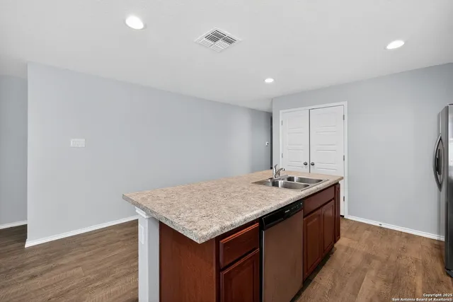 a bathroom with a granite countertop sink