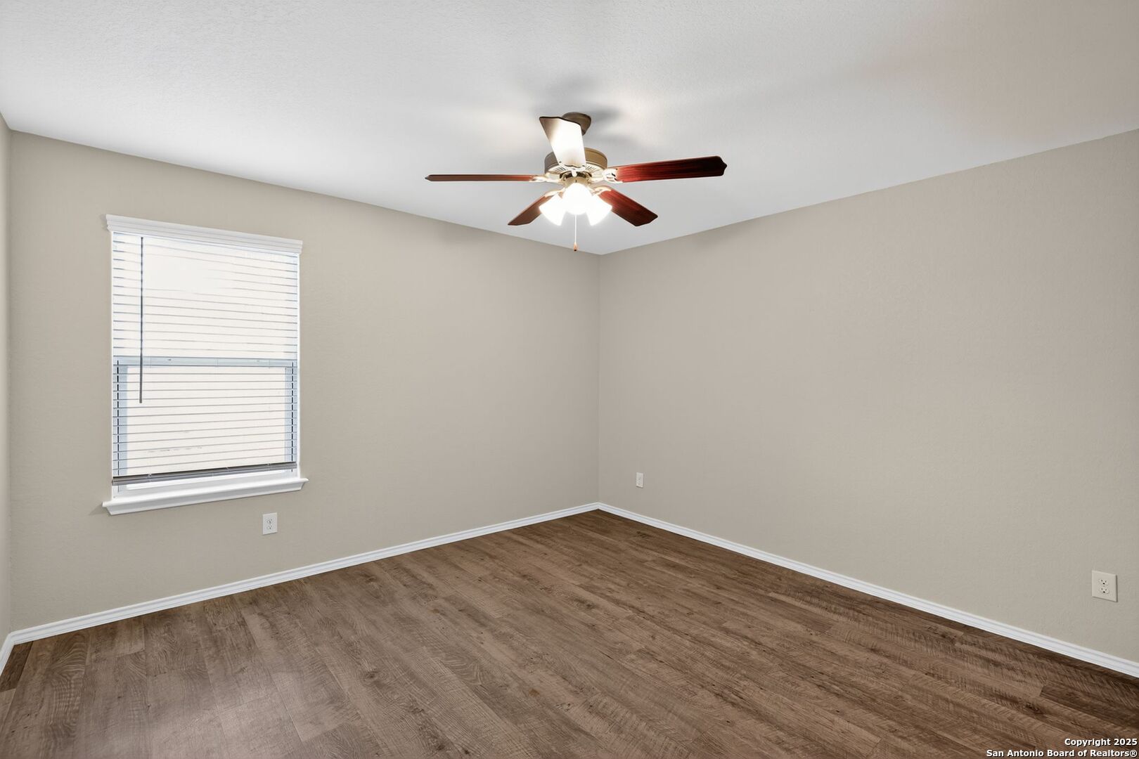 3921 Asher Alley St. Hedwig, TX 78152 - Photo 22 of 30 an empty room with wooden floor ceiling fan and window