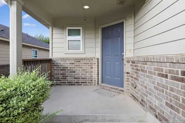 a view of front door of house with an window