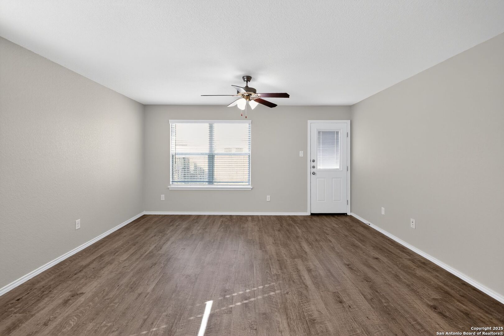 3921 Asher Alley St. Hedwig, TX 78152 - Photo 5 of 30 an empty room with wooden floor and windows