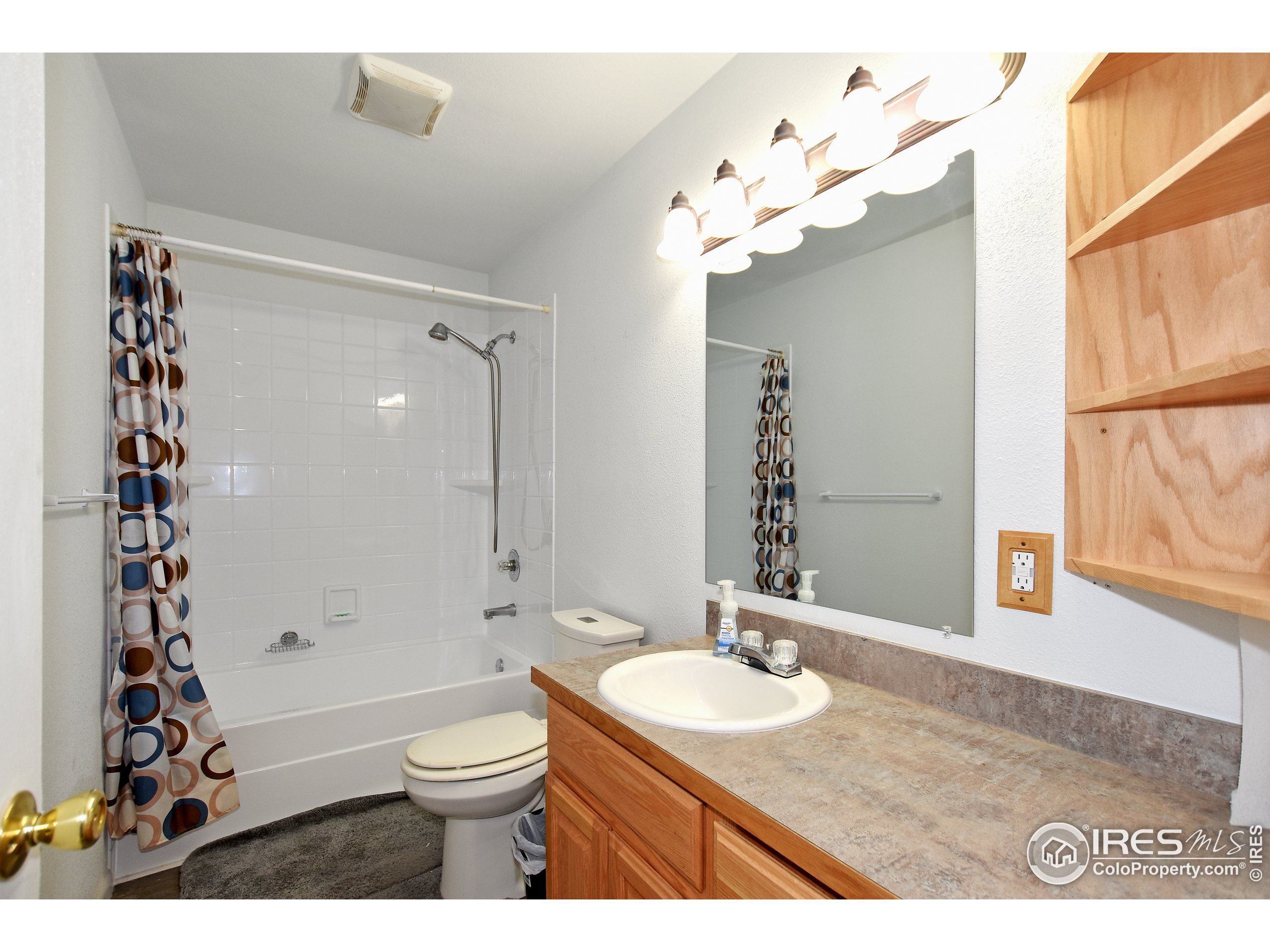 207 Cave Avenue Pierce, CO 80650 - Photo 12 of 35 a bathroom with a granite countertop sink a toilet and a mirror