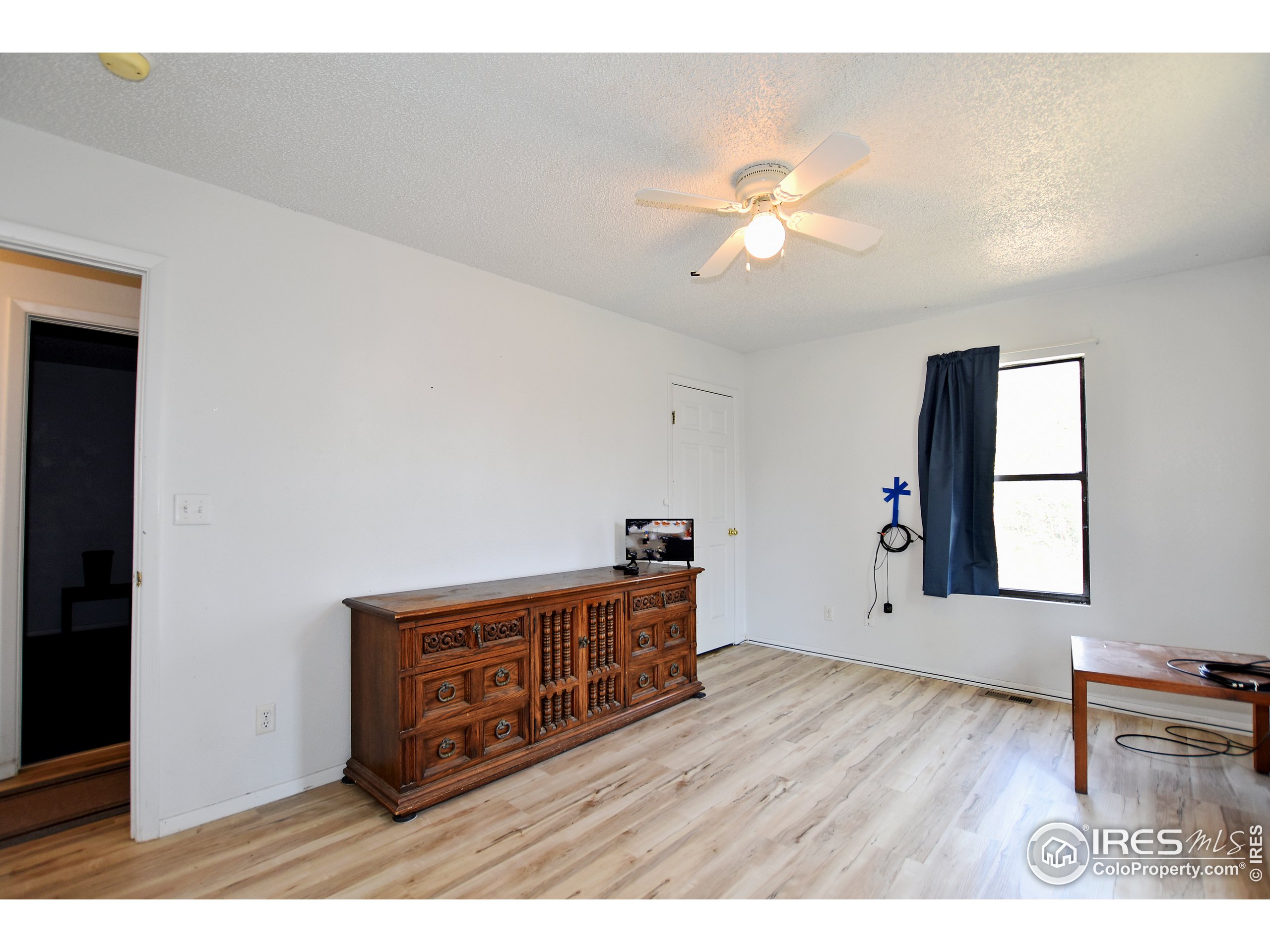 207 Cave Avenue Pierce, CO 80650 - Photo 15 of 35 a living room with furniture and a wooden floor