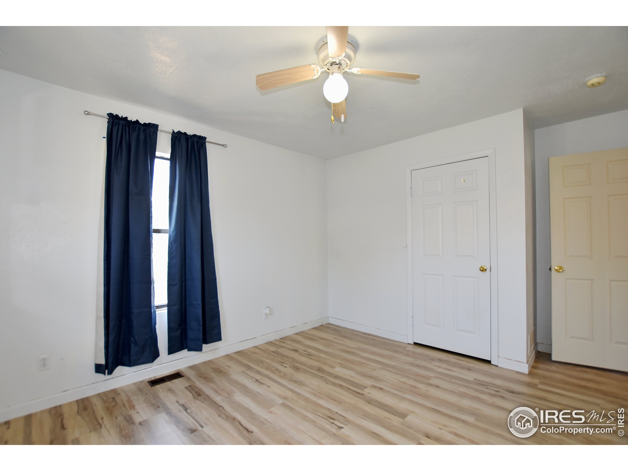 207 Cave Avenue Pierce, CO 80650 - Photo 17 of 35 wooden floor in an empty room with a window