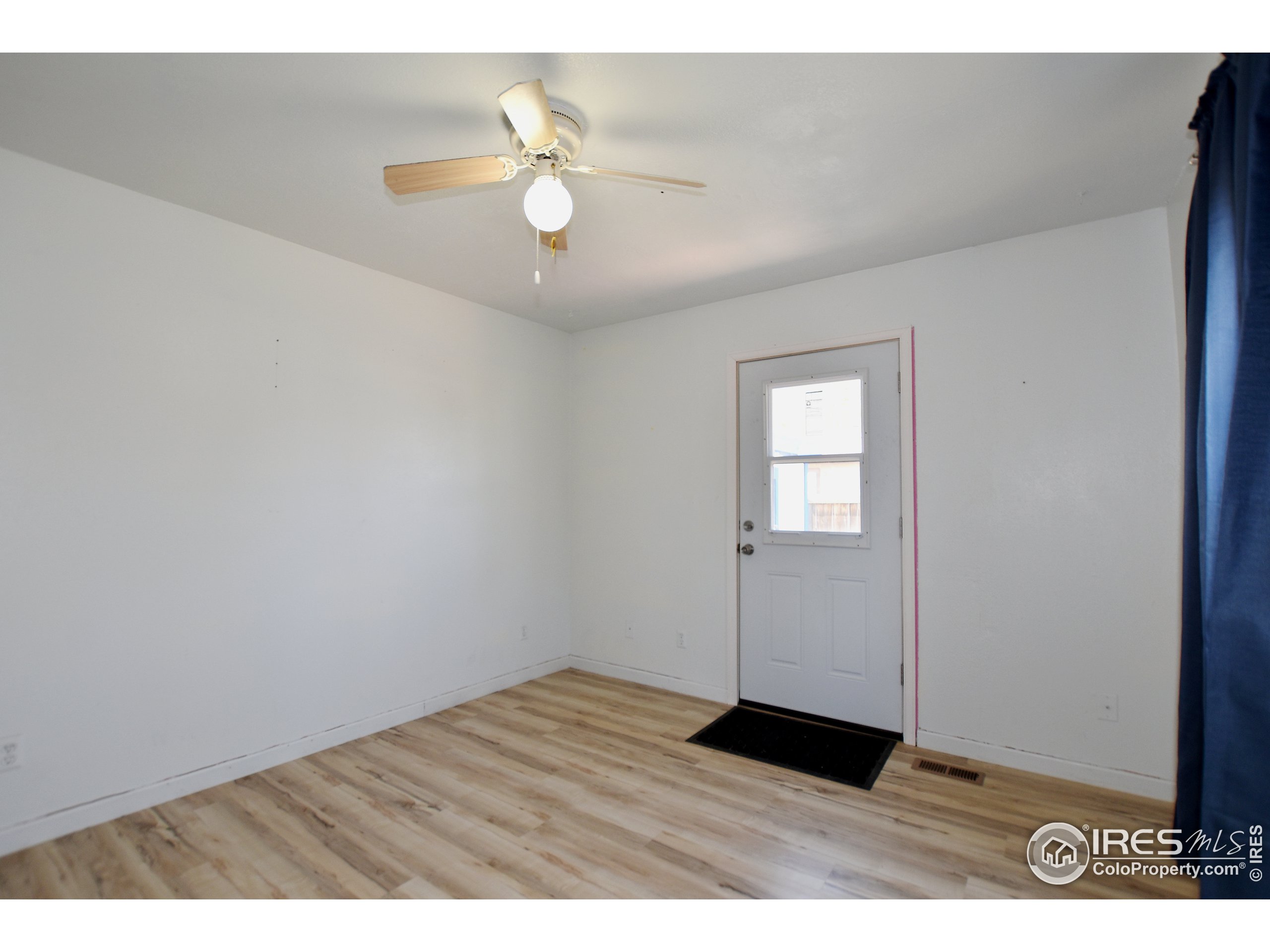207 Cave Avenue Pierce, CO 80650 - Photo 18 of 35 a view of an empty room with wooden floor