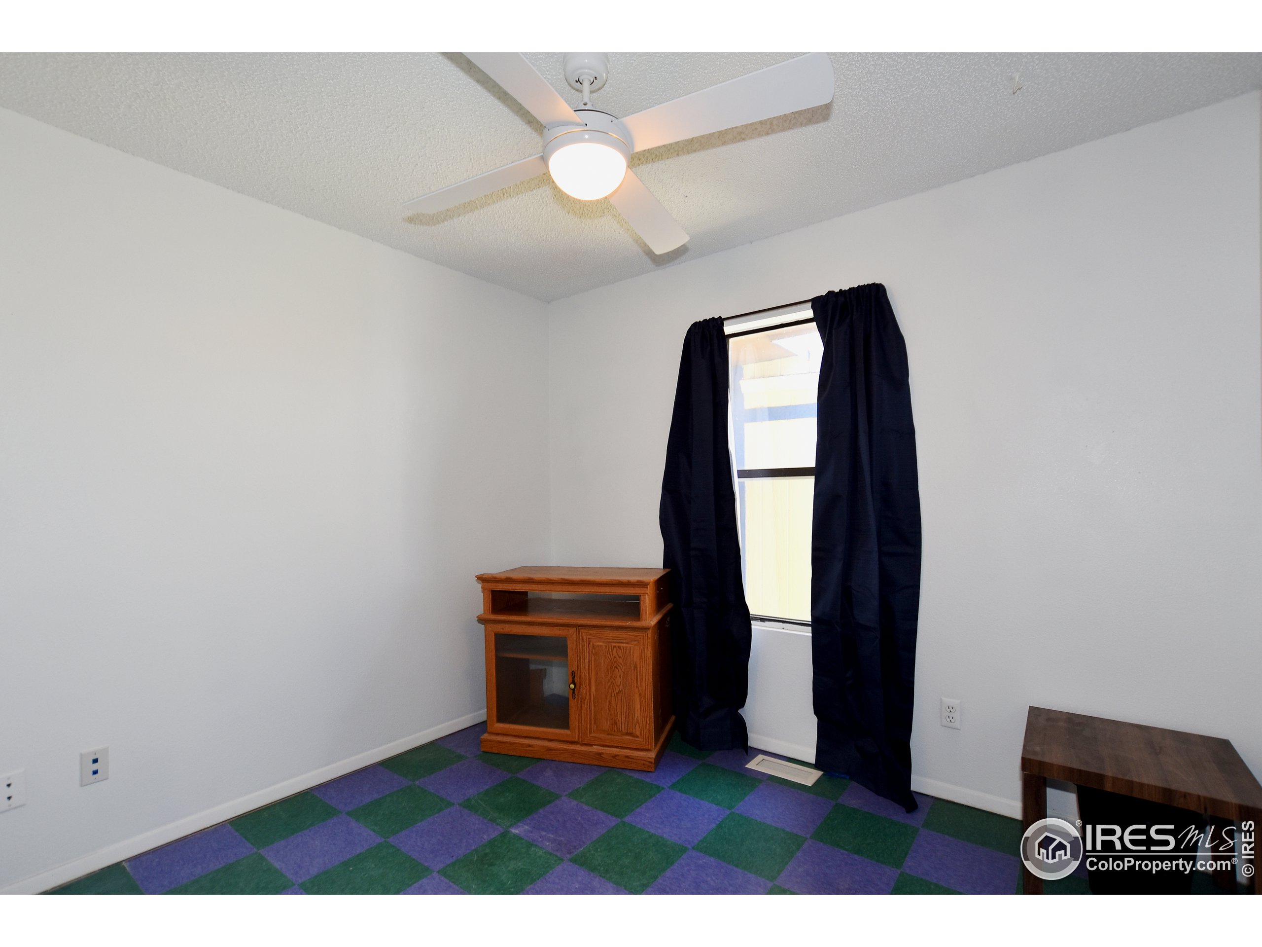 207 Cave Avenue Pierce, CO 80650 - Photo 20 of 35 a view of an empty room with wooden floor and a window