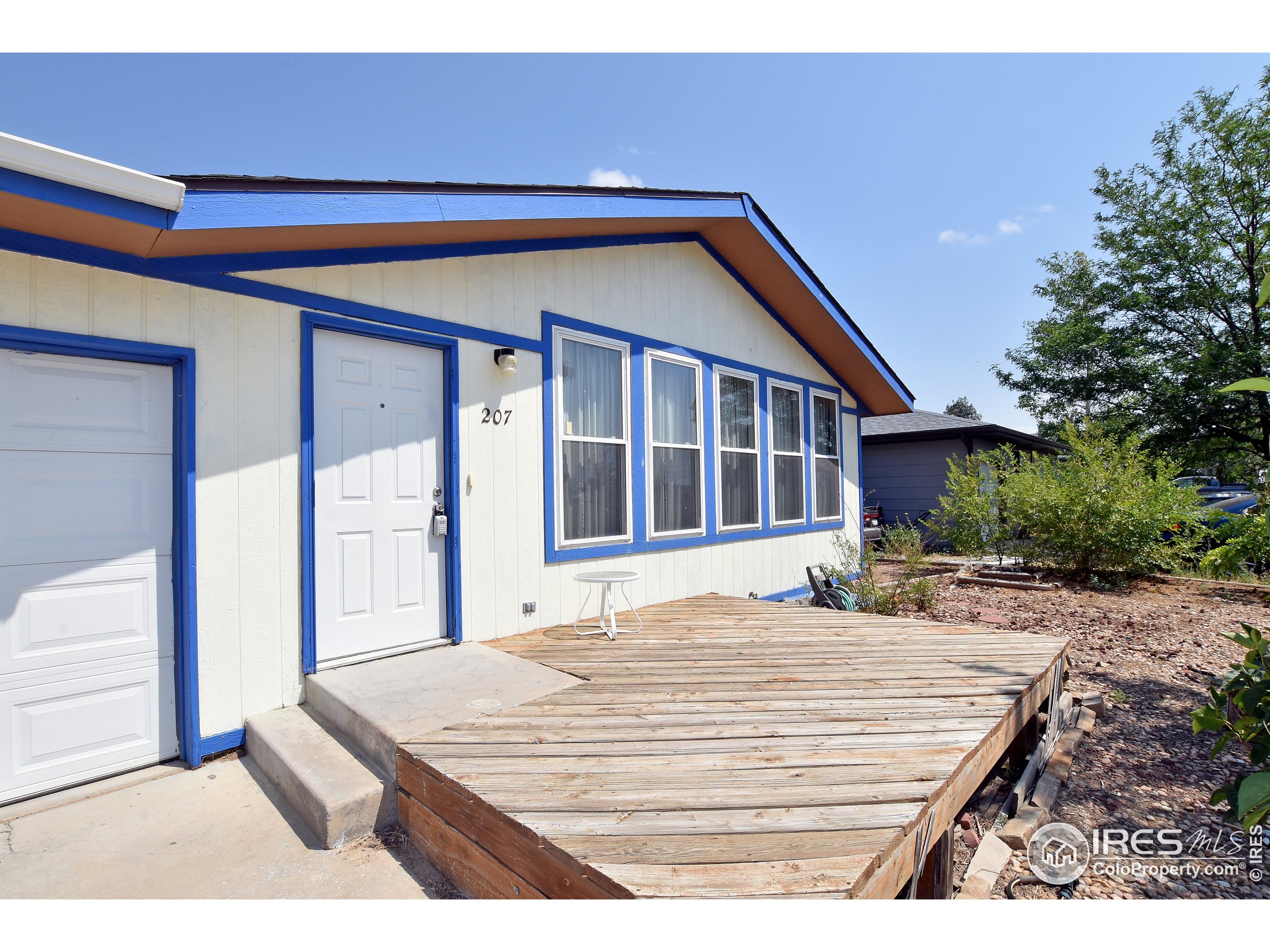 207 Cave Avenue Pierce, CO 80650 - Photo 2 of 35 a front view of a house with a yard