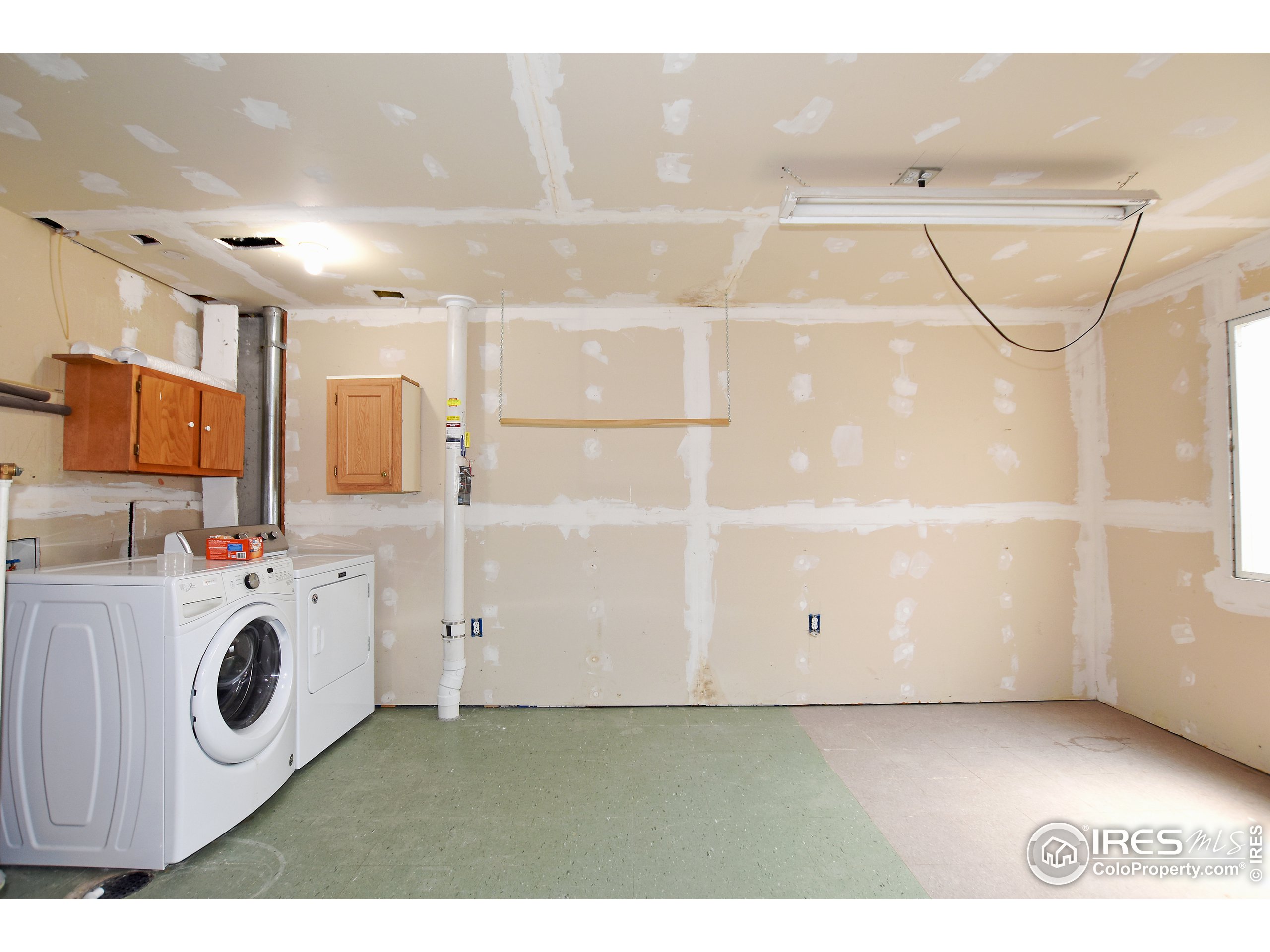 207 Cave Avenue Pierce, CO 80650 - Photo 26 of 35 a kitchen with a white cabinets and white appliances