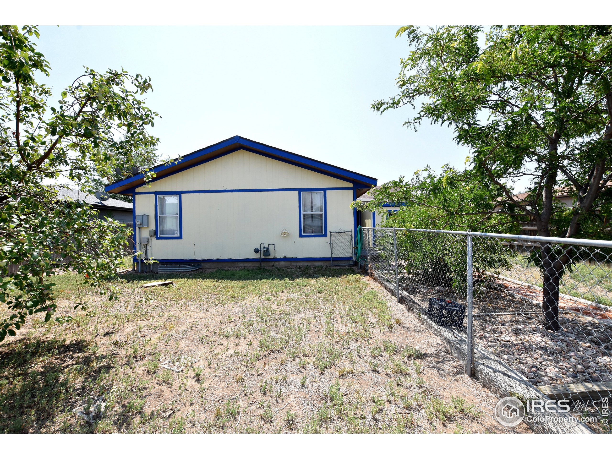 207 Cave Avenue Pierce, CO 80650 - Photo 34 of 35 a house with trees in the background
