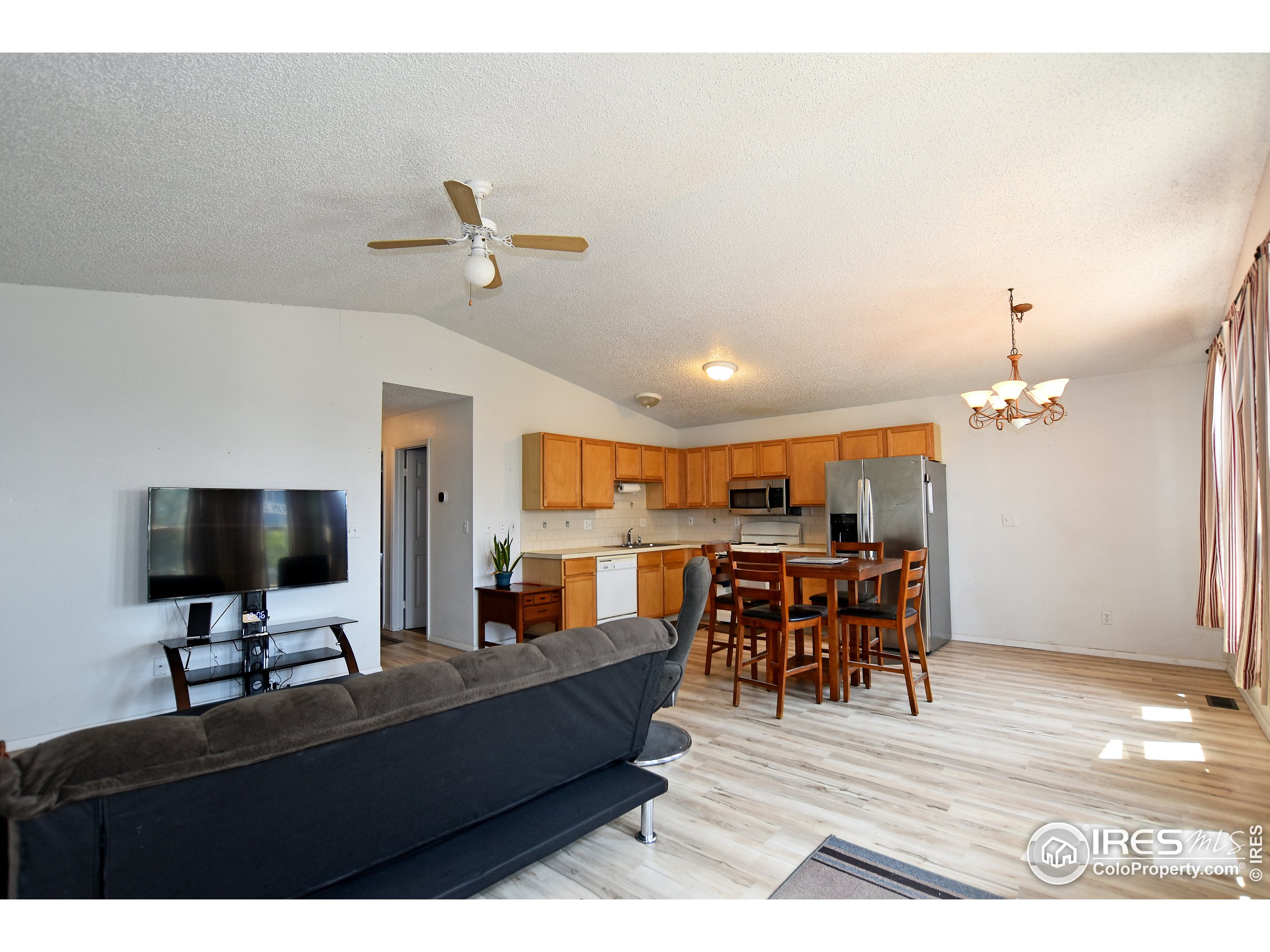 207 Cave Avenue Pierce, CO 80650 - Photo 4 of 35 a living room with furniture and a flat screen tv