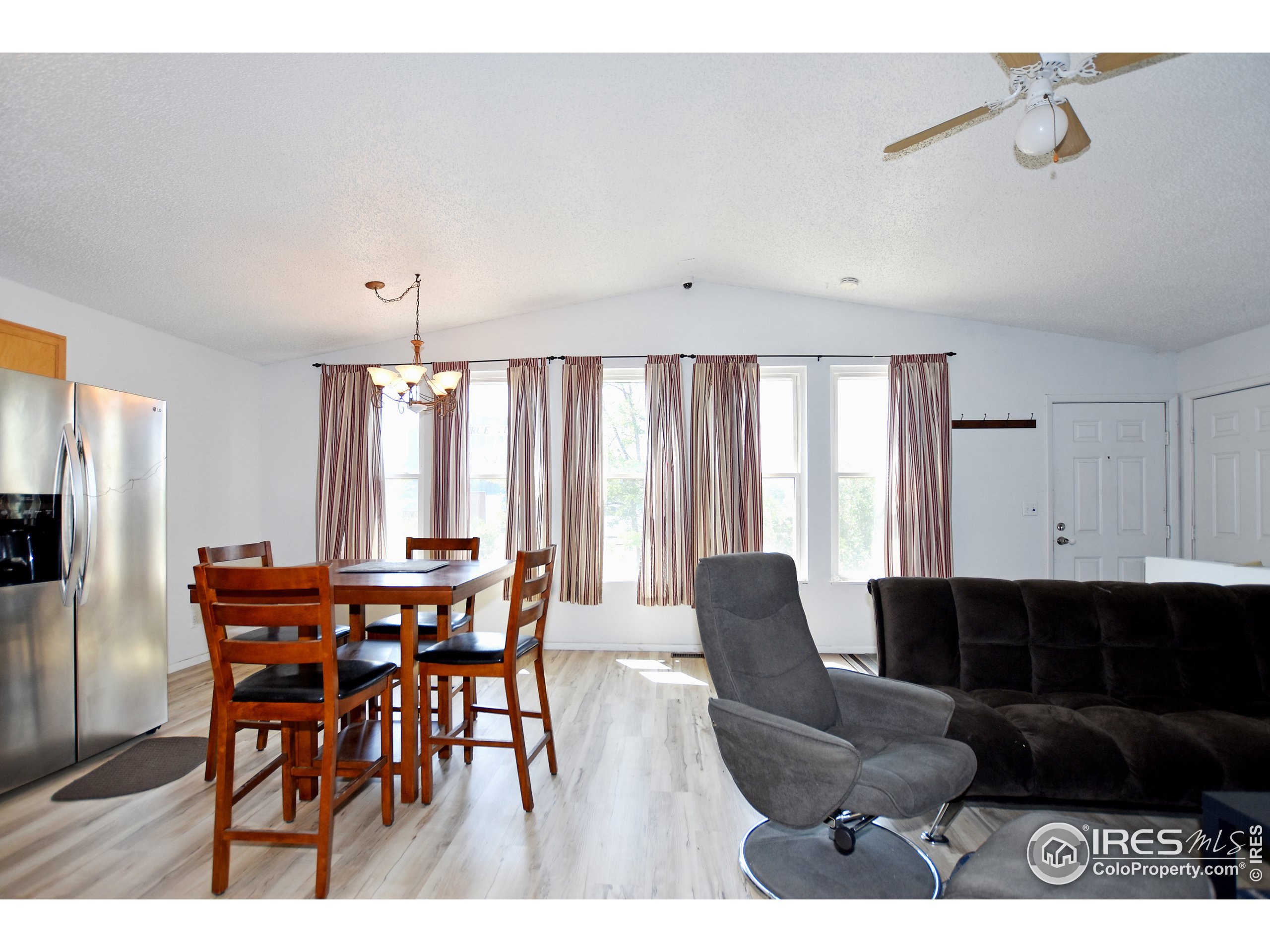 207 Cave Avenue Pierce, CO 80650 - Photo 5 of 35 a view of a dining room with furniture and a window