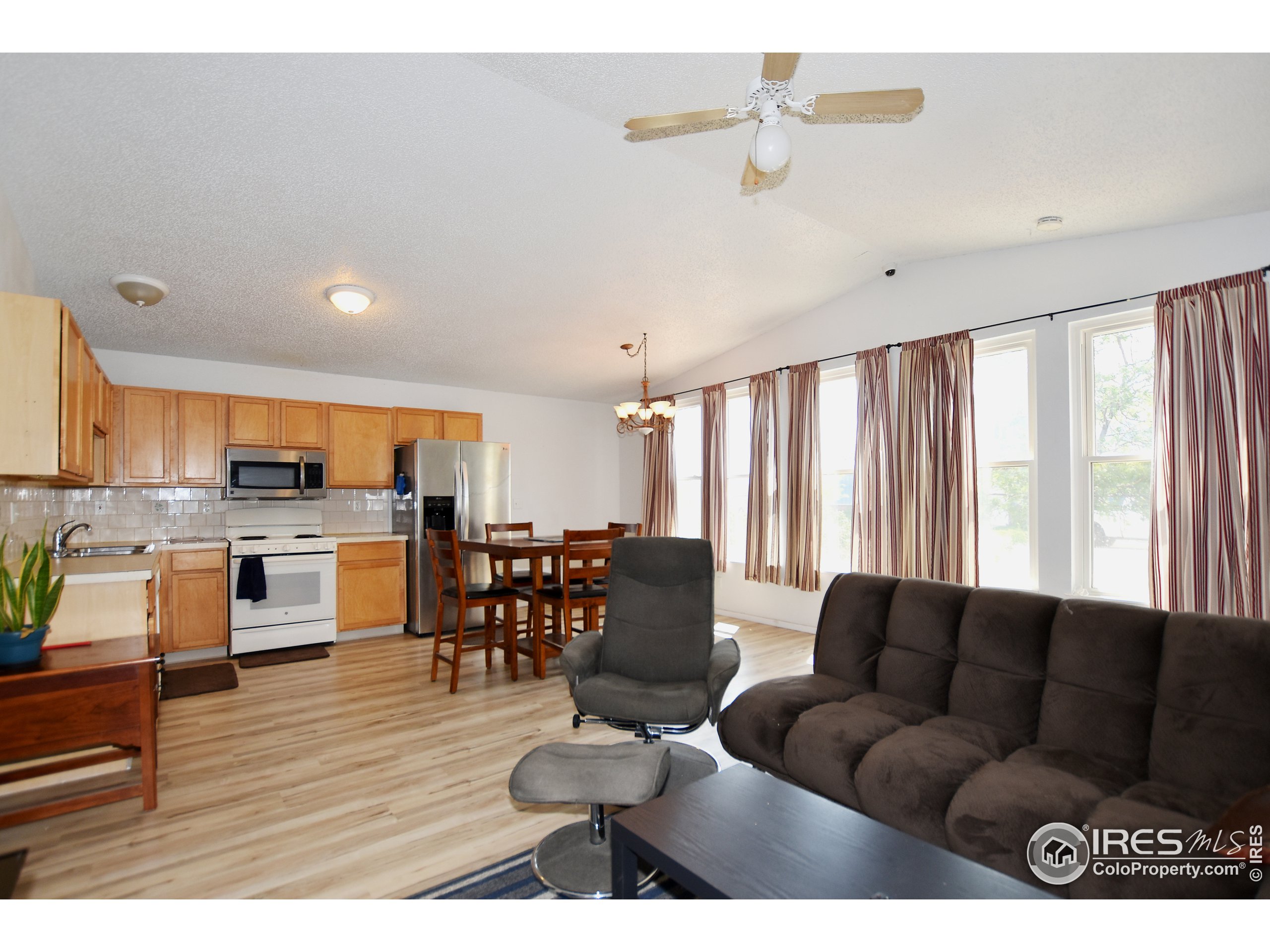 207 Cave Avenue Pierce, CO 80650 - Photo 6 of 35 a living room with furniture kitchen view and a large window