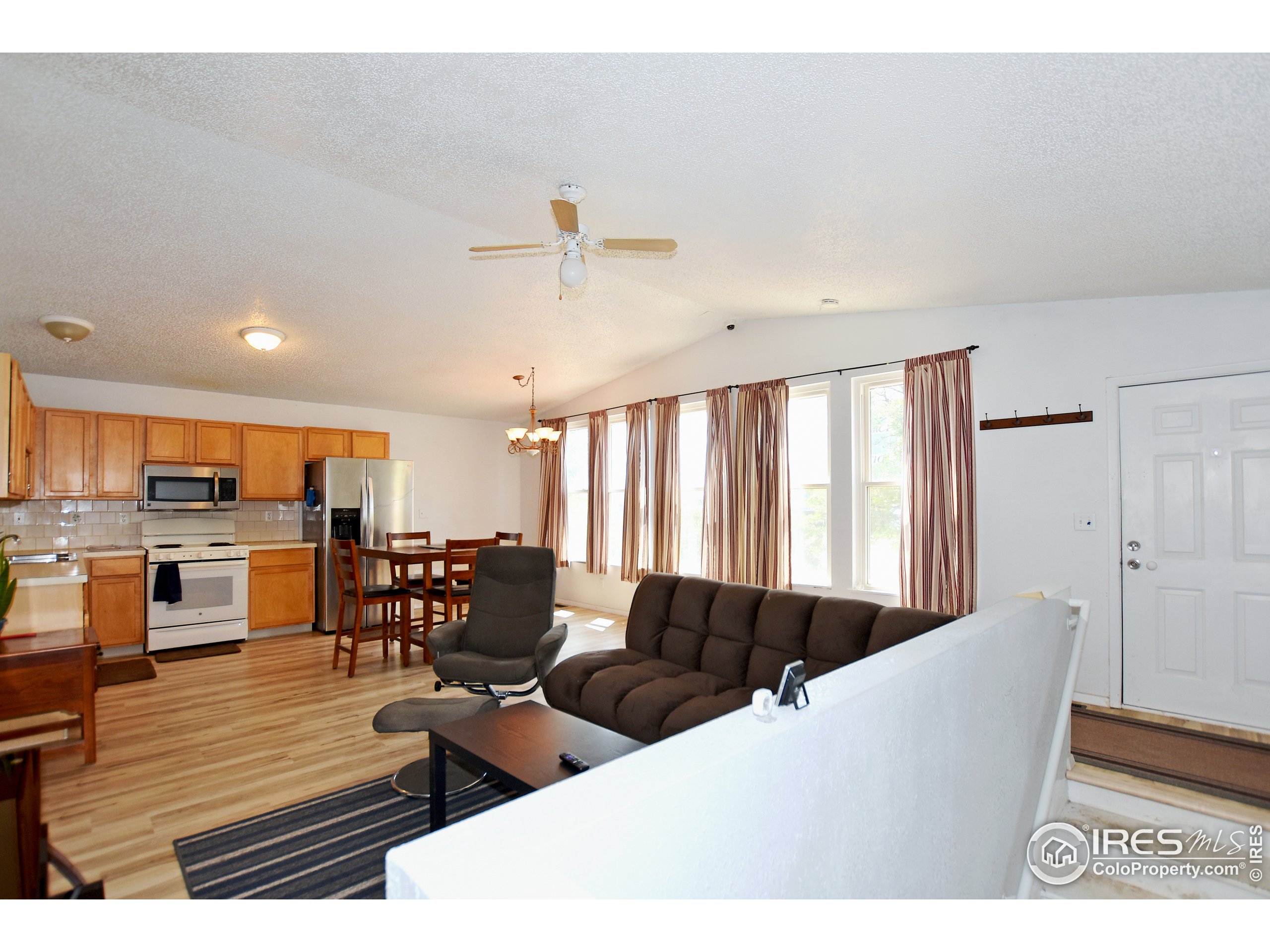 207 Cave Avenue Pierce, CO 80650 - Photo 7 of 35 a living room with furniture wooden floor and kitchen view