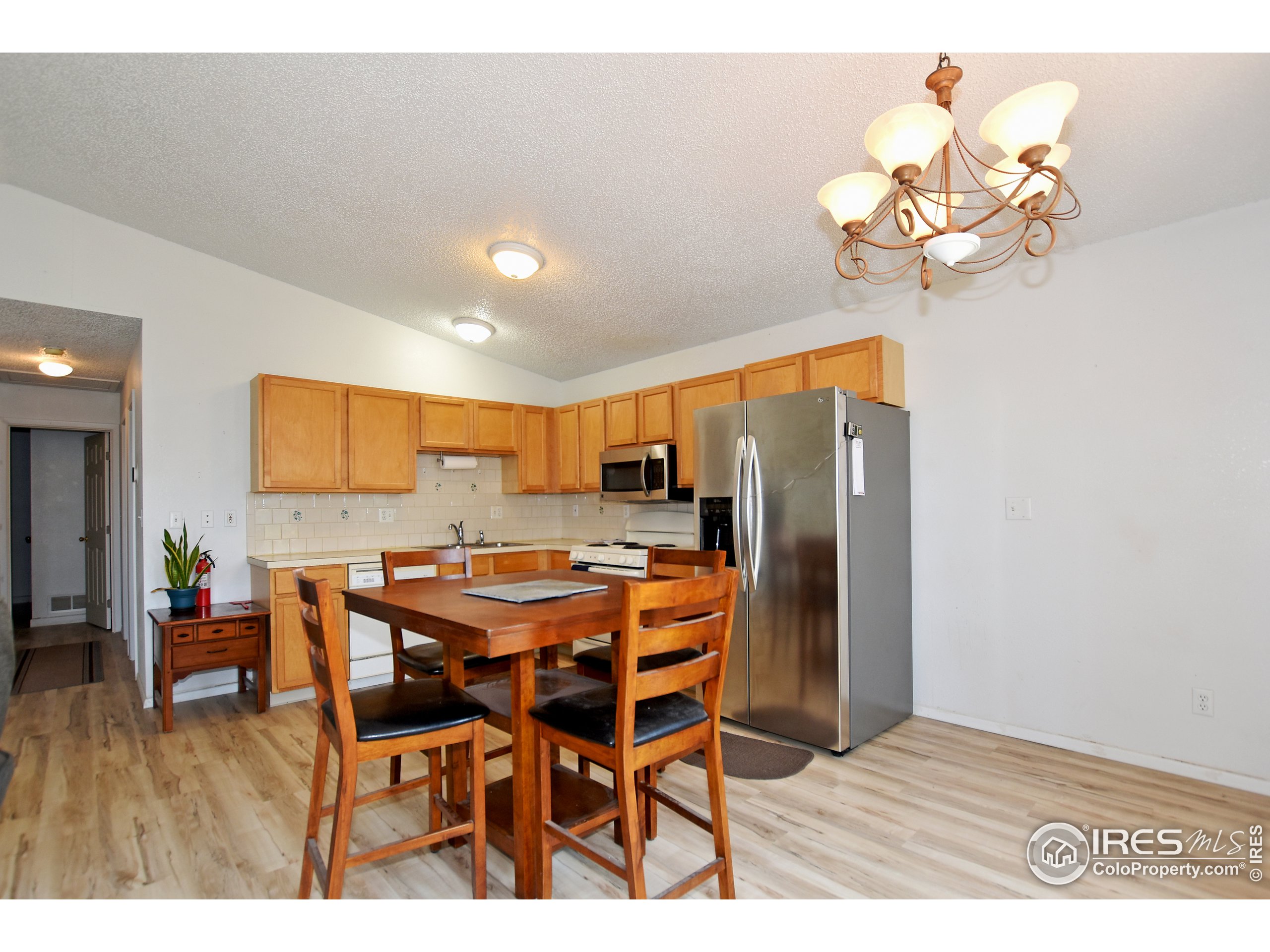 207 Cave Avenue Pierce, CO 80650 - Photo 9 of 35 a view of a dining room with furniture wooden floor and chandelier