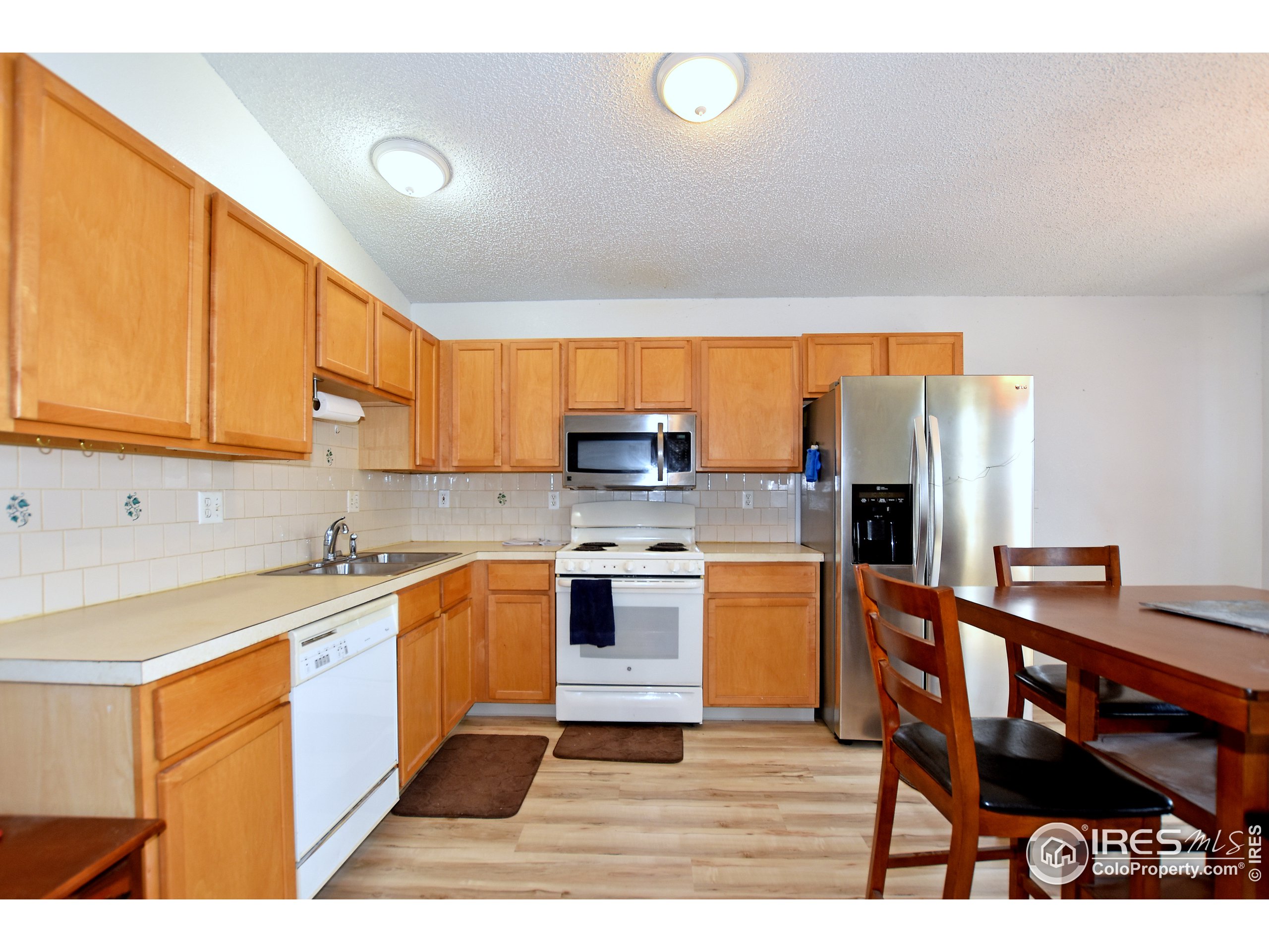 207 Cave Avenue Pierce, CO 80650 - Photo 10 of 35 a kitchen with stainless steel appliances a stove a sink a microwave and refrigerator
