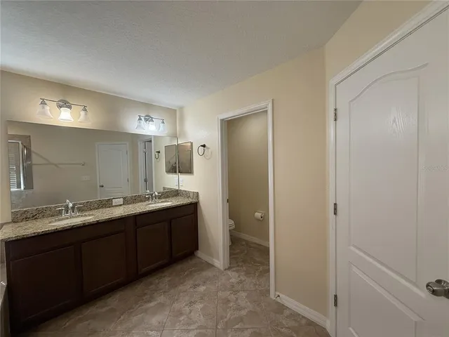 a bathroom with a double vanity sink and mirror