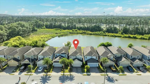 an aerial view of house with yard and lake view