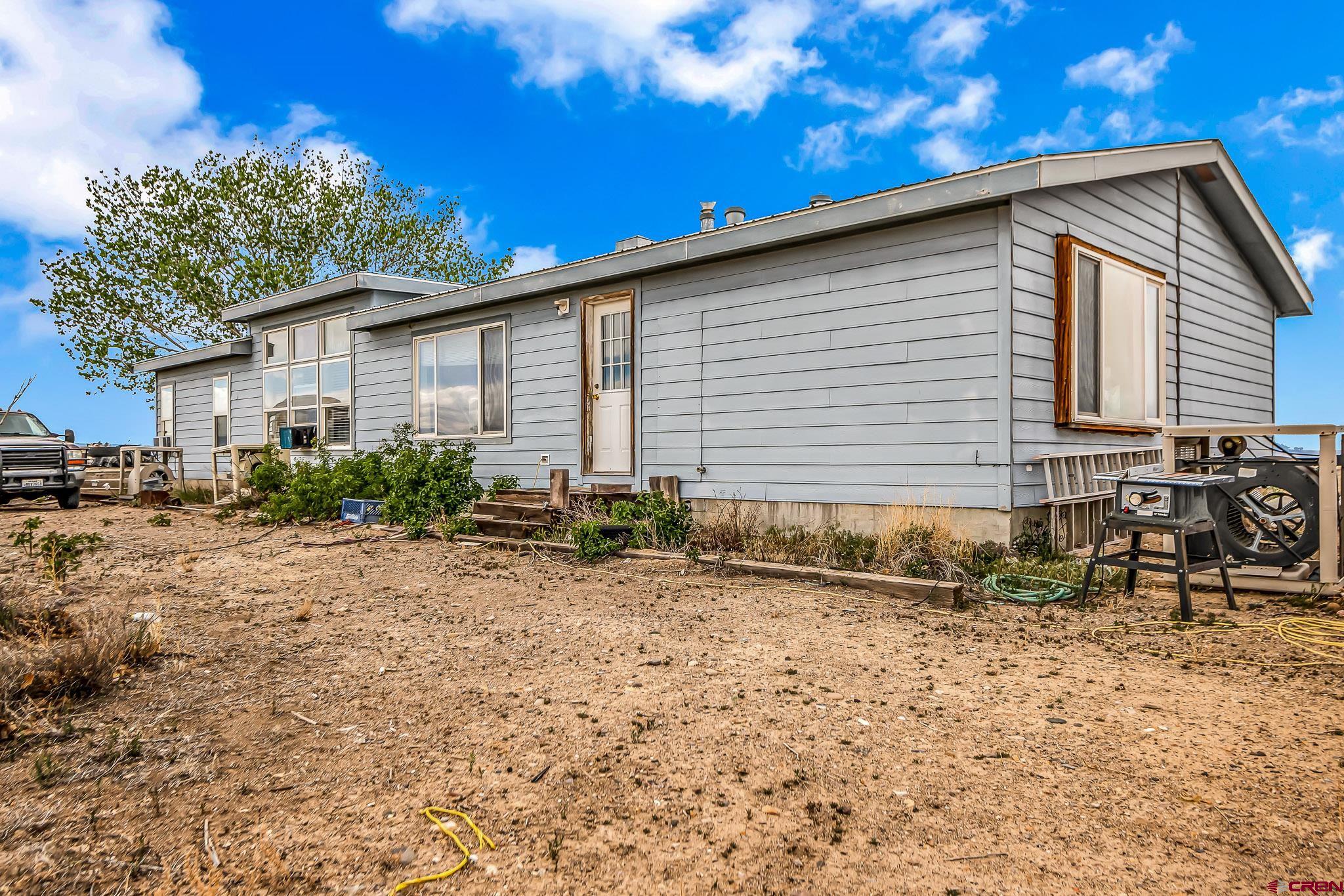 3610 6200 Road Olathe, CO 81425 - Photo 15 of 24 a view of a house with a yard