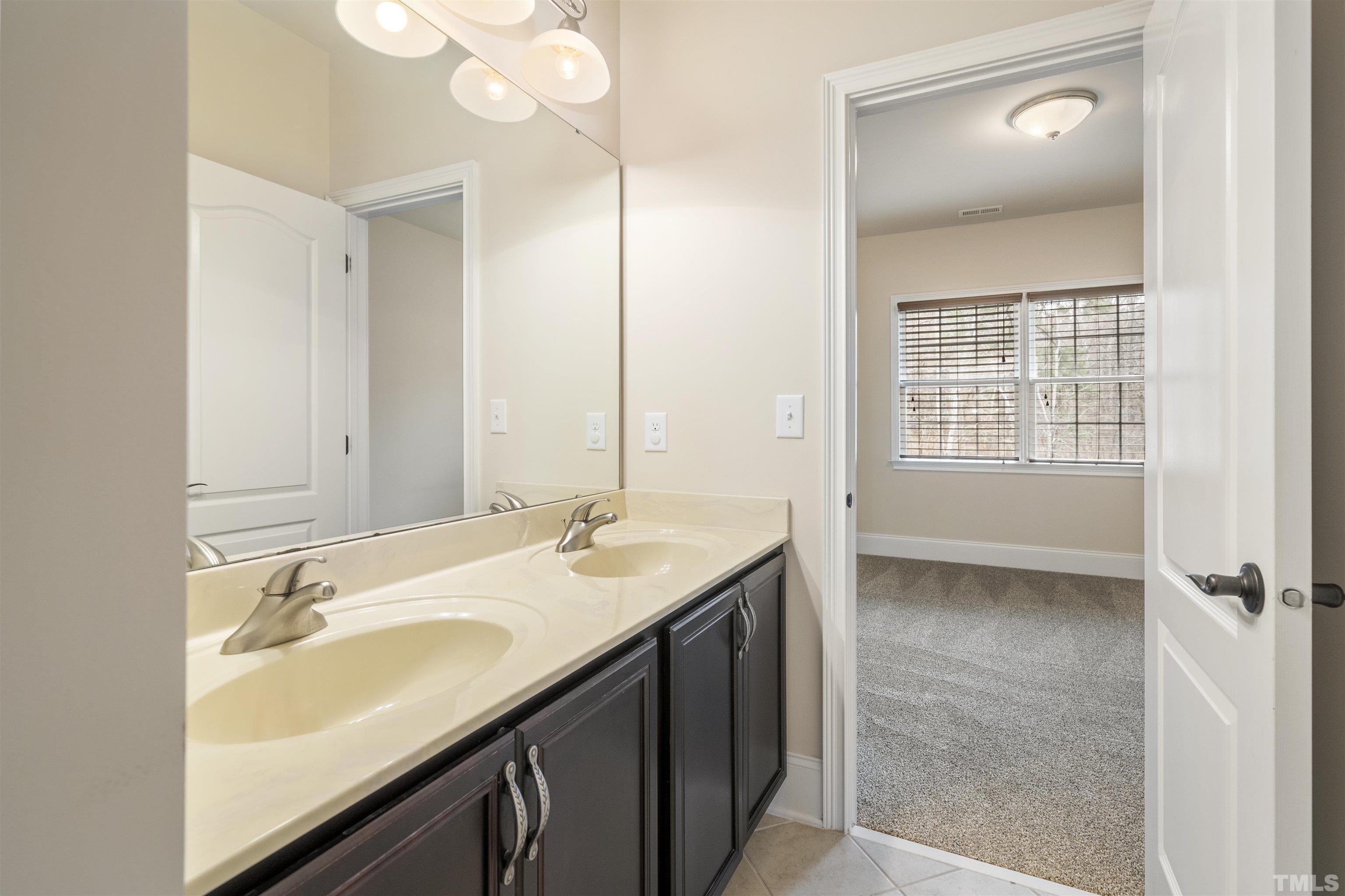 4109 Piney Gap Drive Cary, NC 27519 - Photo 18 of 39 a bathroom with a sink double vanity and a mirror