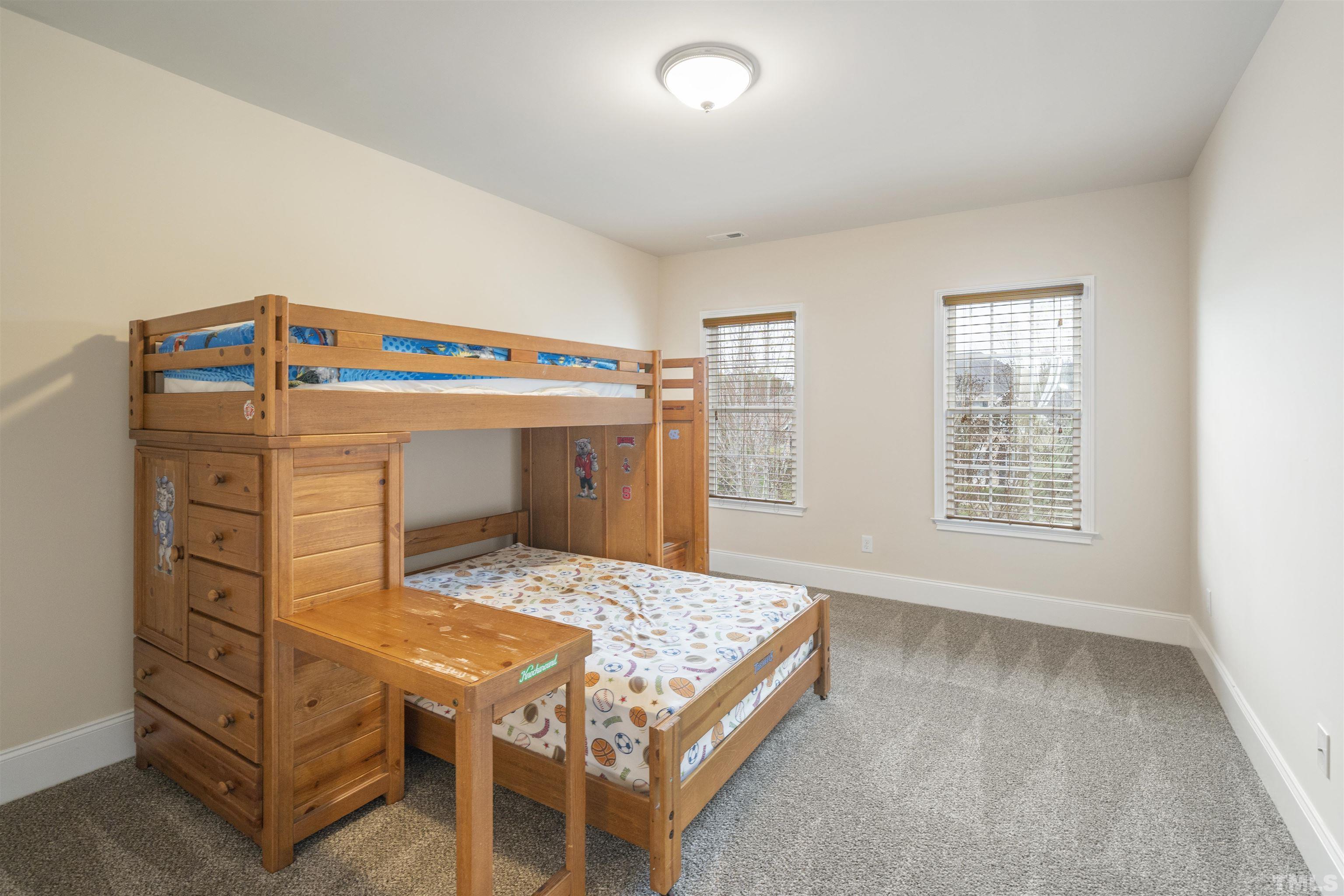 4109 Piney Gap Drive Cary, NC 27519 - Photo 19 of 39 a bedroom with a bed and a dresser
