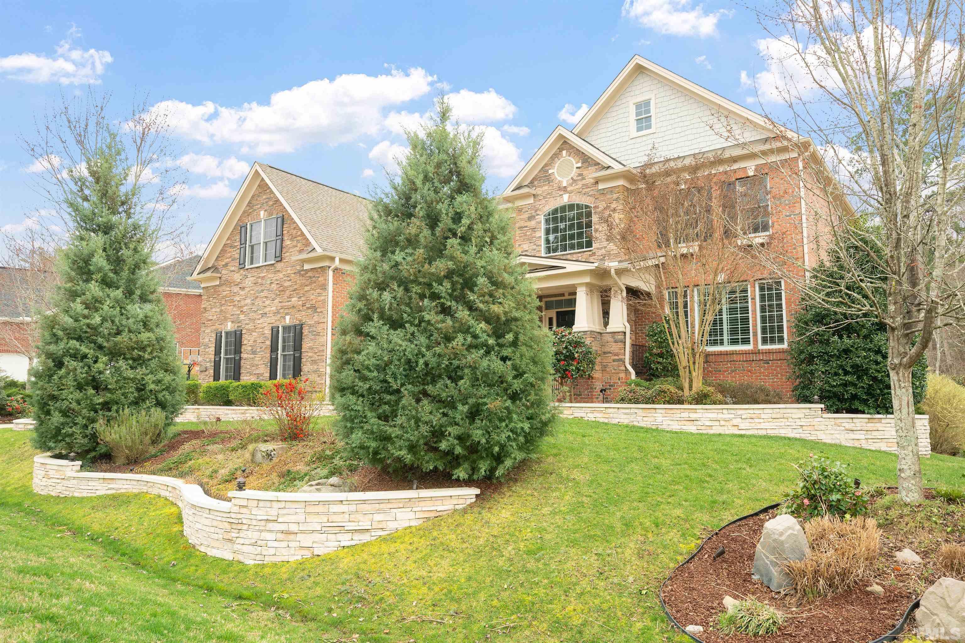 4109 Piney Gap Drive Cary, NC 27519 - Photo 2 of 39 a front view of a house with a yard and garage