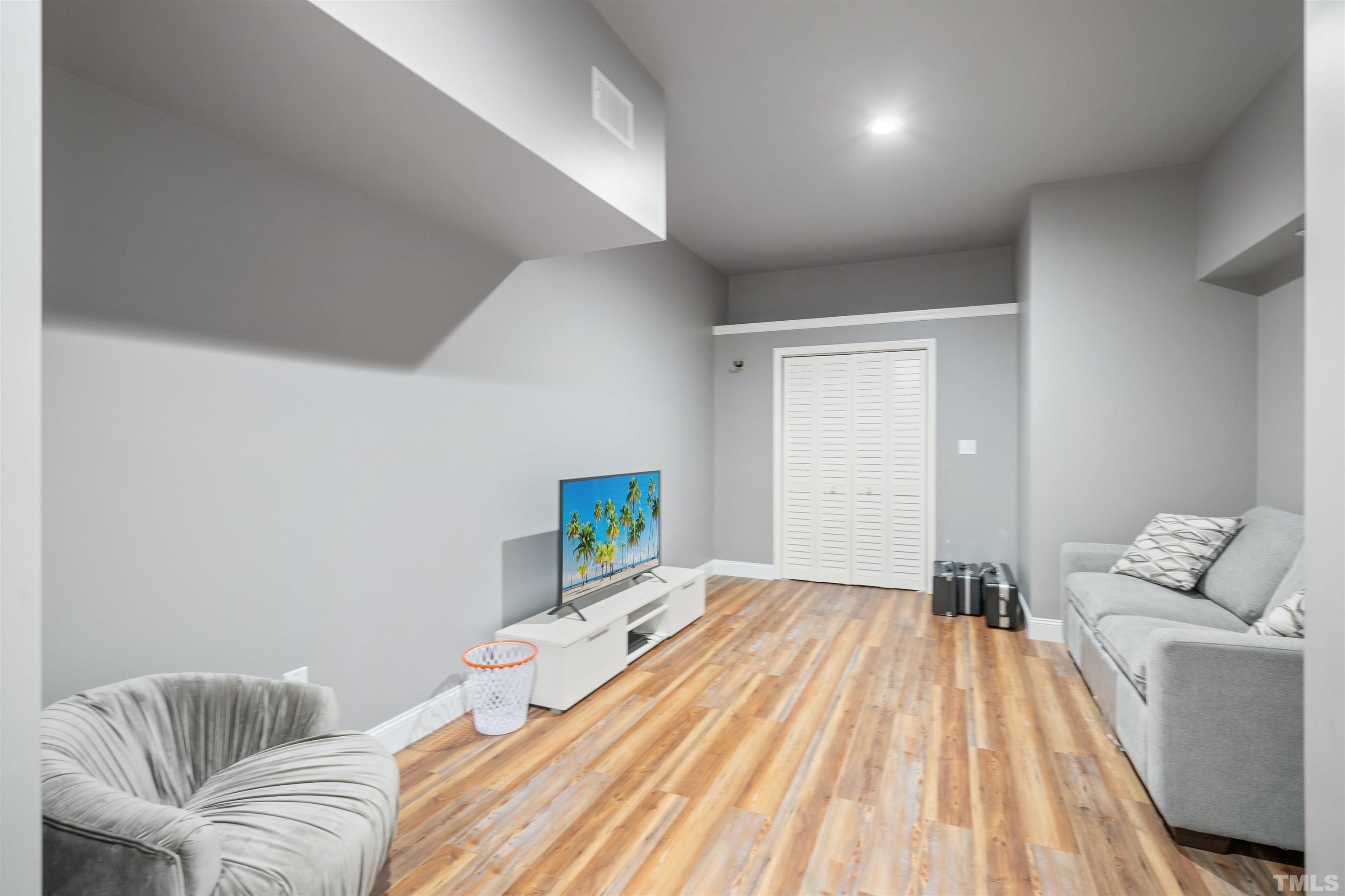 4109 Piney Gap Drive Cary, NC 27519 - Photo 29 of 39 a bedroom with a bed and wooden floor