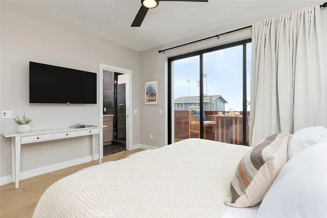 a bedroom with a large bed and a flat screen tv