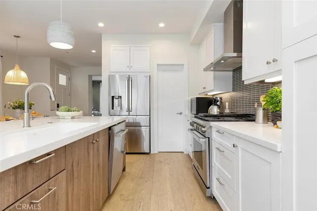 a kitchen with a sink stove and refrigerator