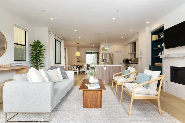 a living room with fireplace furniture and a flat screen tv