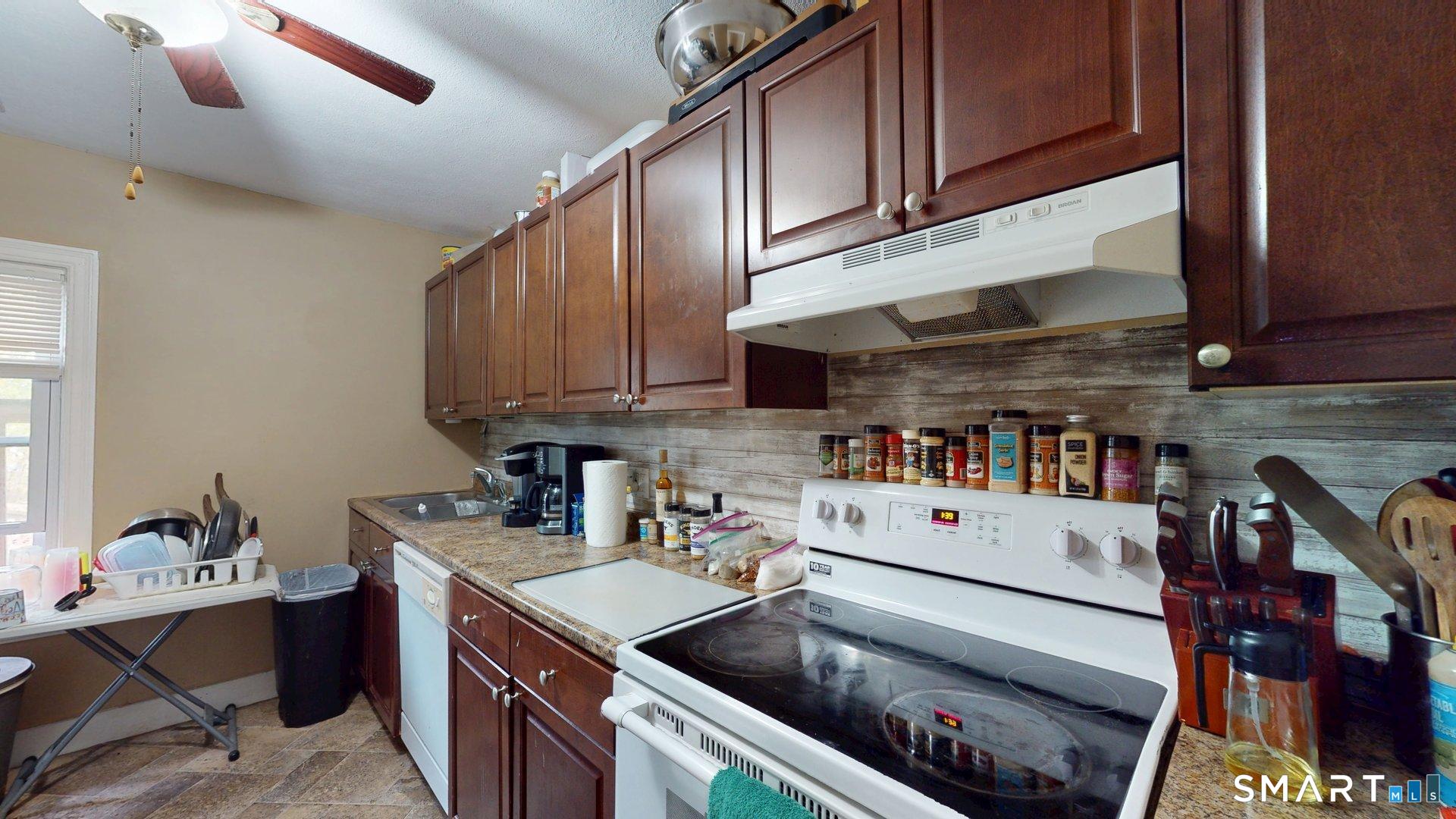 138 Main Street Somers, CT 06071 - Photo 19 of 40 a kitchen with stainless steel appliances granite countertop a sink stove and cabinets